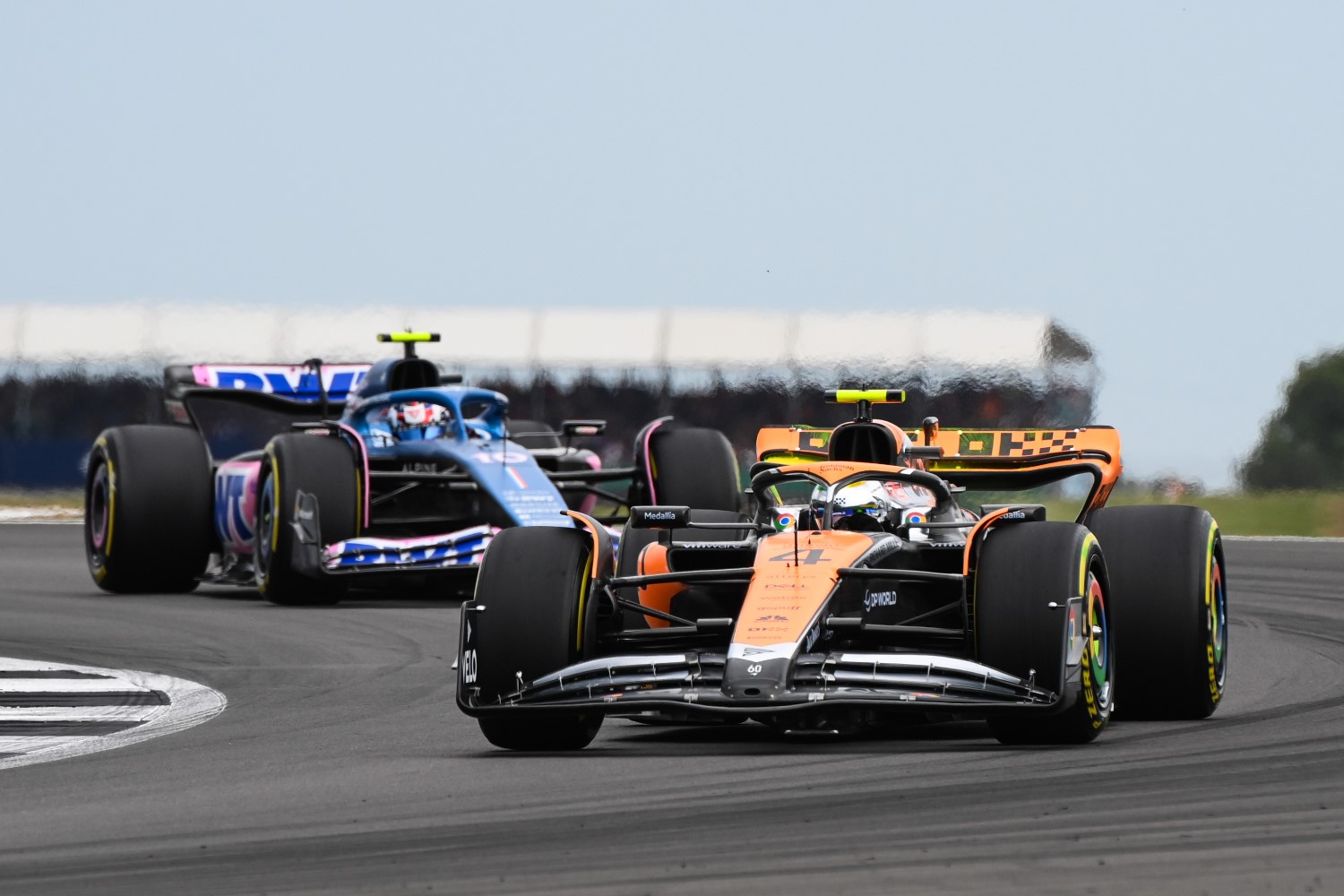 Lando Norris, McLaren MCL60, leads Pierre Gasly, Alpine A523 during the British GP at Silverstone Circuit on Saturday July 08, 2023 in Northamptonshire, United Kingdom. (Photo by Mark Sutton / LAT Images)