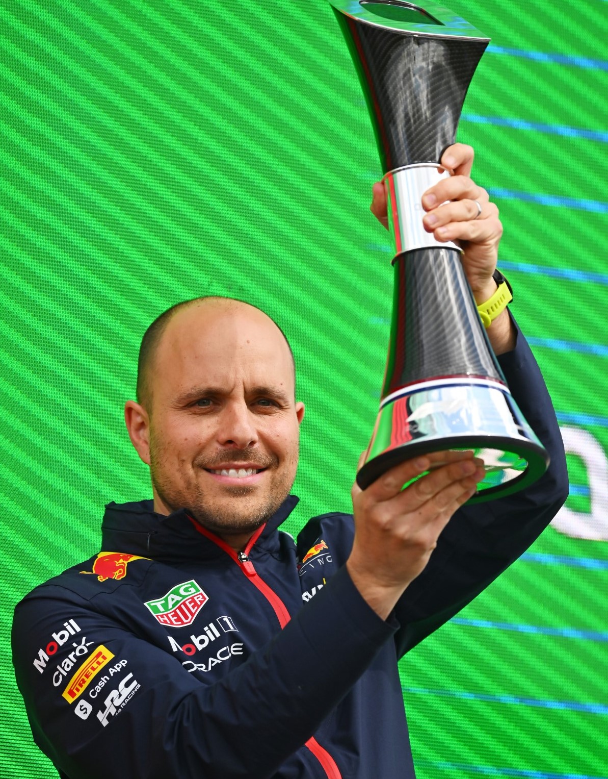 Red Bull Racing race engineer Gianpiero Lambiase celebrates with the constructors' race win trophy on the podium during the F1 Grand Prix of Great Britain at Silverstone Circuit on July 09, 2023 in Northampton, England. (Photo by Rudy Carezzevoli - Formula 1/Formula 1 via Getty Images) // Getty Images / Red Bull Content Pool //