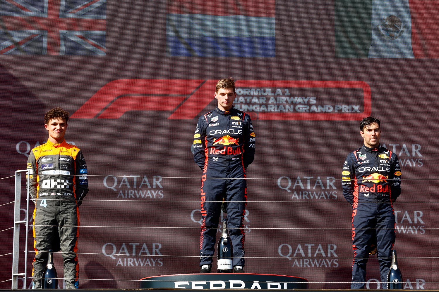 Race winner Max Verstappen of the Netherlands and Oracle Red Bull Racing, Second placed Lando Norris of Great Britain and McLaren and Third placed Sergio Perez of Mexico and Oracle Red Bull Racing celebrate on the podium during the F1 Grand Prix of Hungary at Hungaroring on July 23, 2023 in Budapest, Hungary. (Photo by Francois Nel/Getty Images) // Getty Images / Red Bull Content Pool