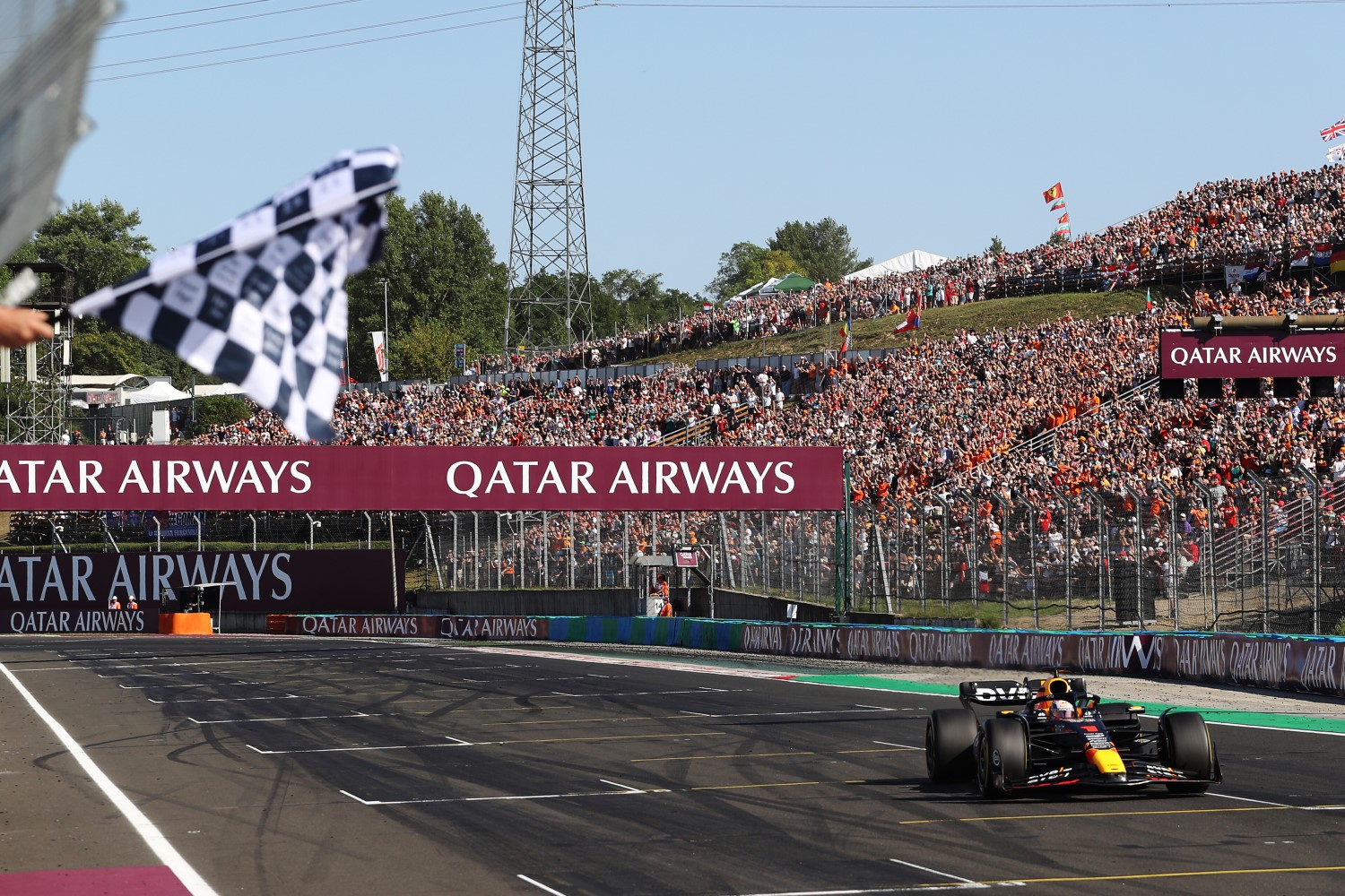 Before a huge crowd, race winner Max Verstappen of the Netherlands driving the (1) Oracle Red Bull Racing RB19 takes the checkered flag during the F1 Grand Prix of Hungary at Hungaroring on July 23, 2023 in Budapest, Hungary. (Photo by Peter Fox/Getty Images) // Getty Images / Red Bull Content Pool
