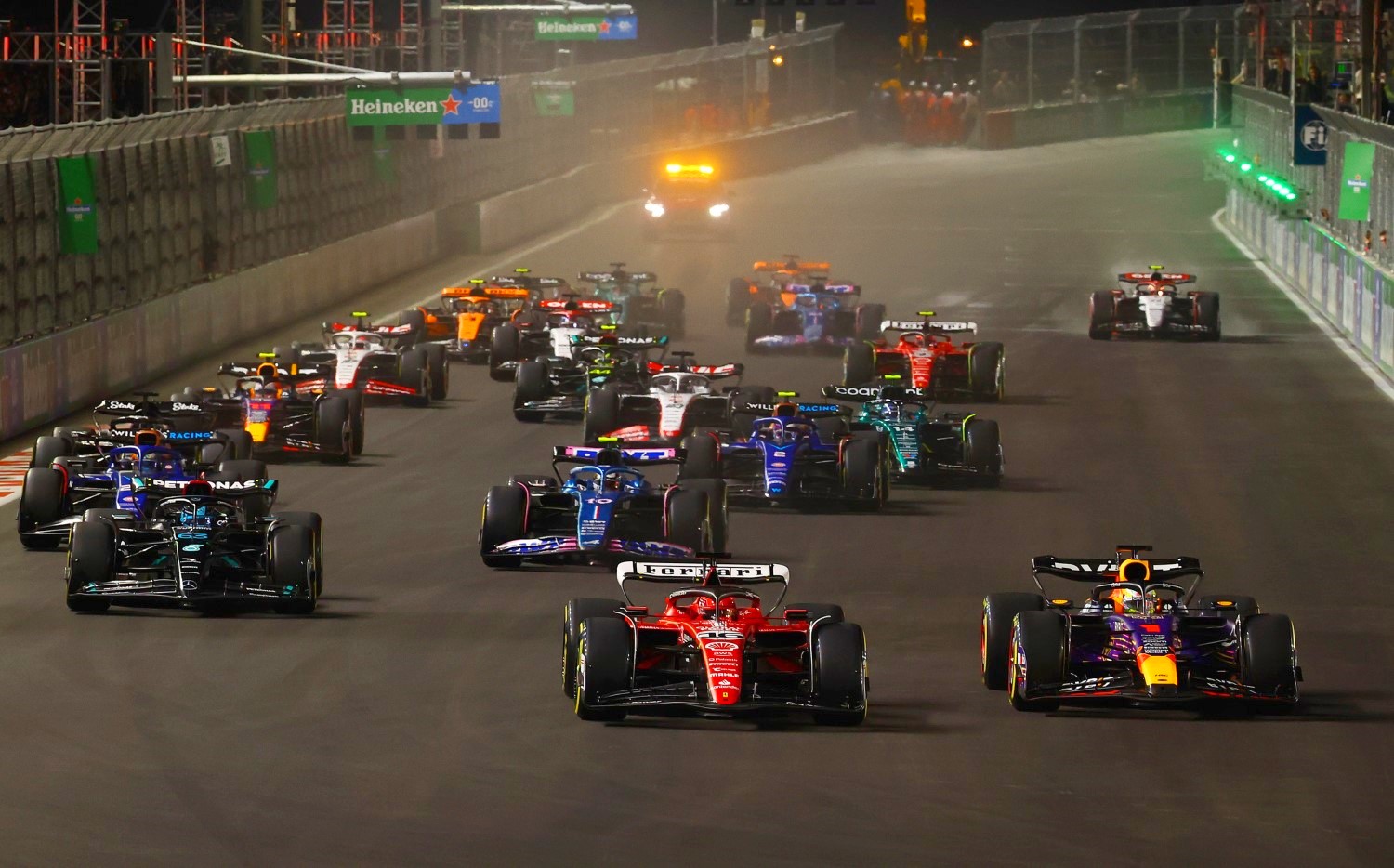 Max Verstappen of the Netherlands driving the (1) Oracle Red Bull Racing RB19 leads Charles Leclerc of Monaco driving the (16) Ferrari SF-23 at turn one during the F1 Grand Prix of Las Vegas at Las Vegas Strip Circuit on November 18, 2023 in Las Vegas, Nevada. (Photo by Mark Thompson/Getty Images) // Getty Images / Red Bull Content Pool