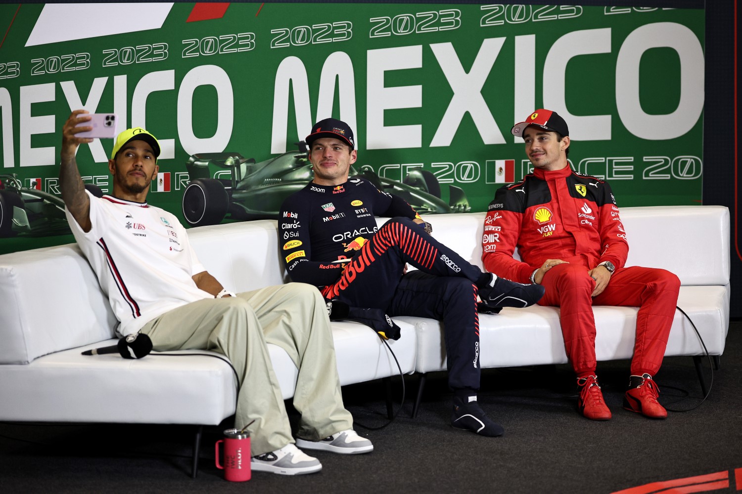 Second placed Lewis Hamilton of Great Britain and Mercedes talks a photo with Race winner Max Verstappen of the Netherlands and Oracle Red Bull Racing and Third placed Charles Leclerc of Monaco and Ferrari as they attend a press conference after the F1 Grand Prix of Mexico at Autodromo Hermanos Rodriguez on October 29, 2023 in Mexico City, Mexico. (Photo by Jared C. Tilton/Getty Images) // Getty Images / Red Bull Content Pool