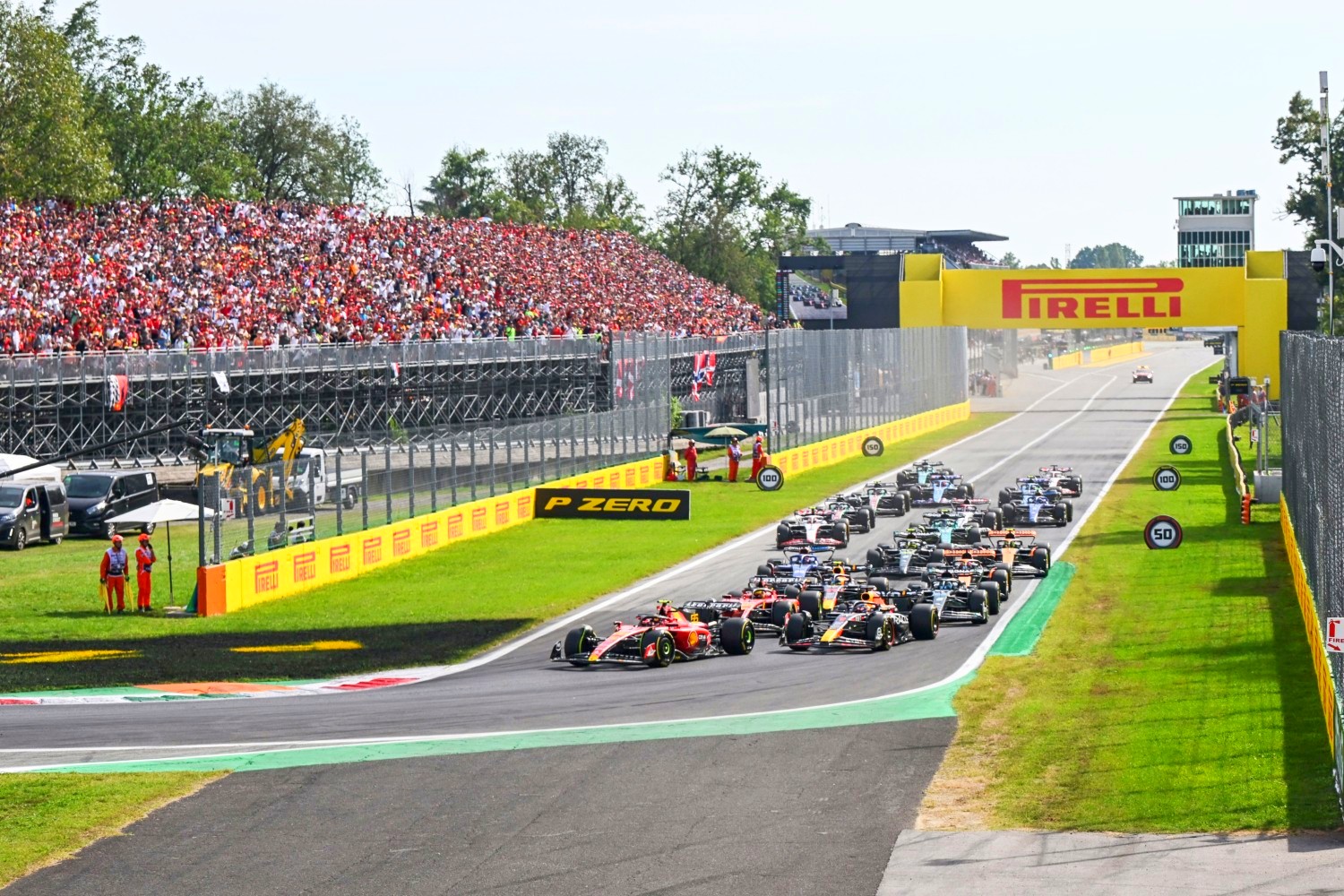 AUTODROMO NAZIONALE MONZA, ITALY - SEPTEMBER 03: Carlos Sainz, Ferrari SF-23, leads Max Verstappen, Red Bull Racing RB19, Charles Leclerc, Ferrari SF-23, George Russell, Mercedes F1 W14, and the rest of the field at the start during the Italian GP at Autodromo Nazionale Monza on Sunday September 03, 2023 in Monza, Italy. (Photo by Simon Galloway / LAT Images)