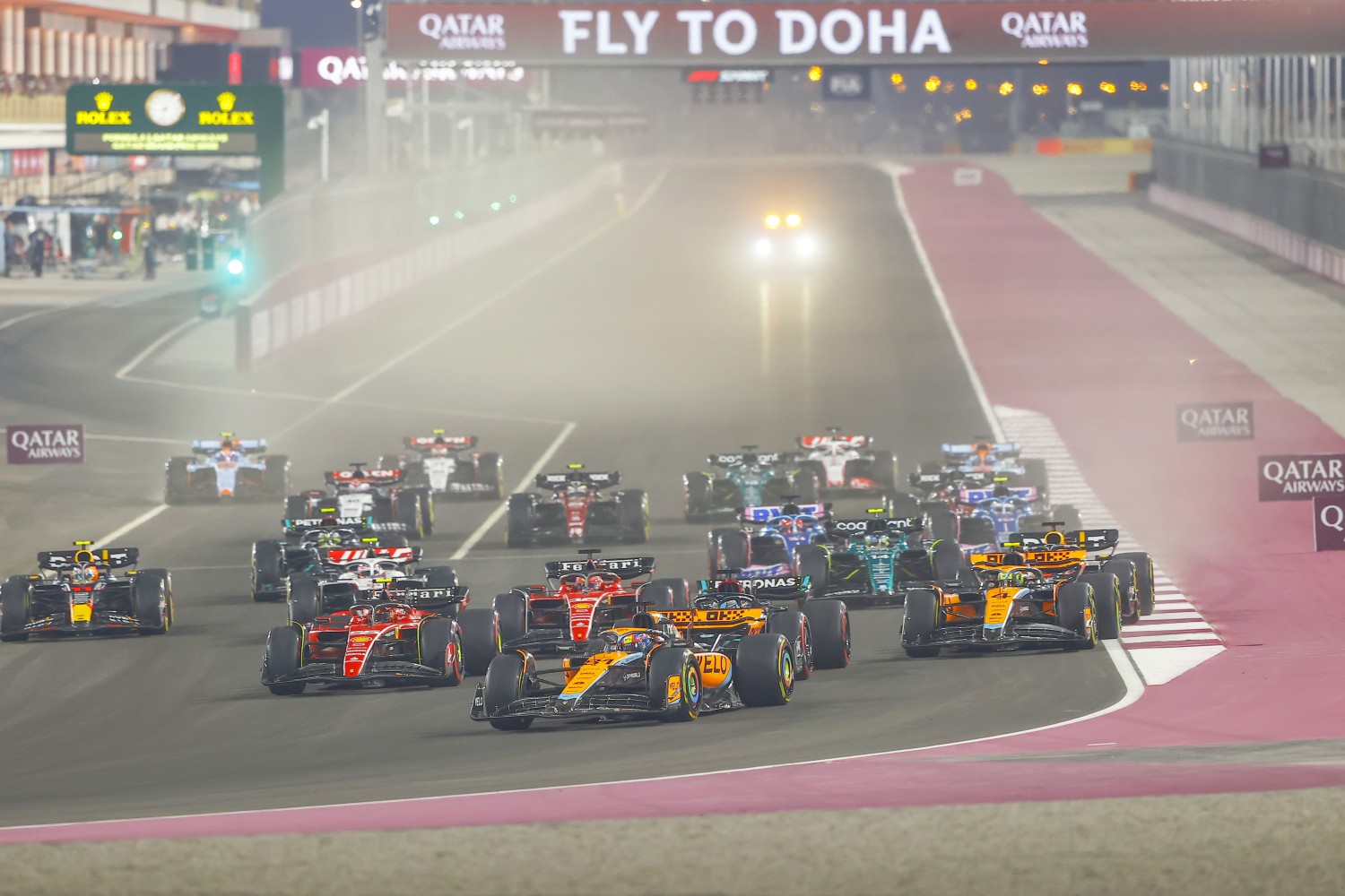 Oscar Piastri, McLaren MCL60, leads Lando Norris, McLaren MCL60, Max Verstappen, Red Bull Racing RB19, Carlos Sainz, Ferrari SF-23, Charles Leclerc, Ferrari SF-23, Fernando Alonso, Aston Martin AMR23, and the rest of the field at the start