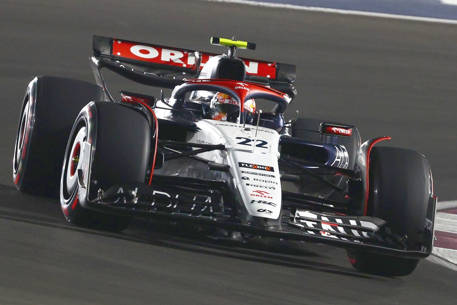 Yuki Tsunoda of Japan driving the (22) Scuderia AlphaTauri AT04 on the way to the grid prior to the Sprint ahead of the F1 Grand Prix of Qatar at Lusail International Circuit on October 07, 2023 in Lusail City, Qatar. (Photo by Clive Rose/Getty Images)