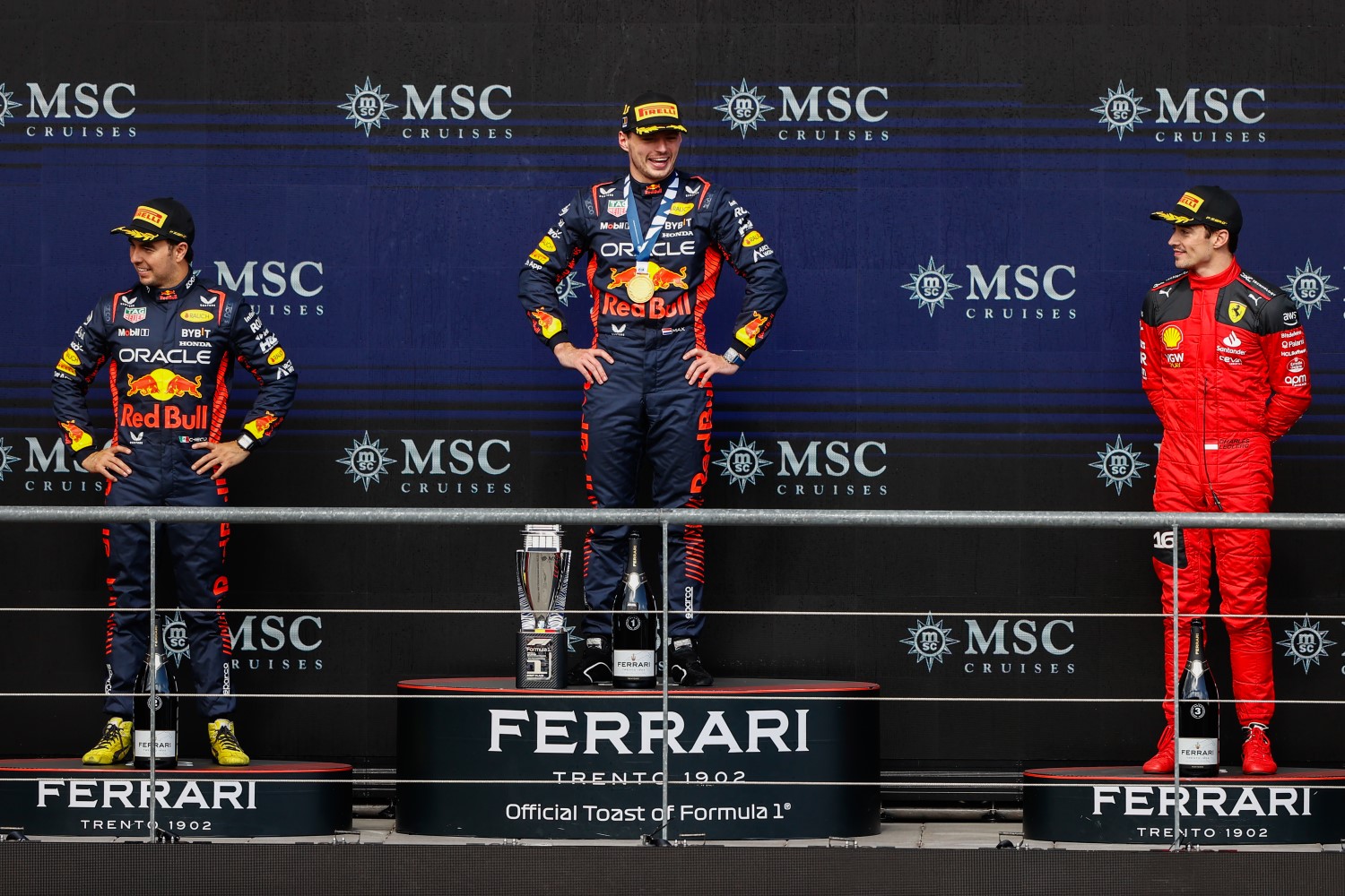 Sergio Perez, Red Bull Racing, 2nd position, Max Verstappen, Red Bull Racing, 1st position, and Charles Leclerc, Scuderia Ferrari, 3rd position, on the podium during the Belgian GP at Circuit de Spa Francorchamps on Sunday July 30, 2023 in Spa, Belgium. (Photo by Andy Hone / LAT Images)