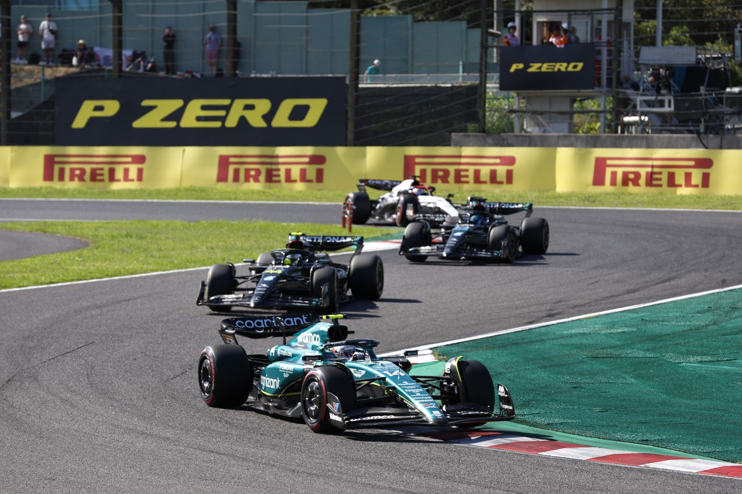 Fernando Alonso, Aston Martin AMR23, leads Sir Lewis Hamilton, Mercedes F1 W14, and George Russell, Mercedes F1 W14 during the Japanese GP at Suzuka on Sunday September 24, 2023 in Suzuka, Japan. (Photo by Steven Tee / LAT Images)
