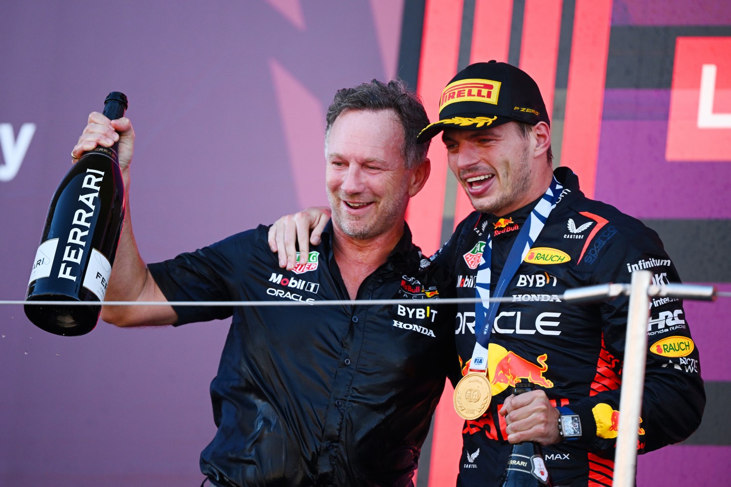 Race winner Max Verstappen of the Netherlands and Oracle Red Bull Racing and Red Bull Racing Team Principal Christian Horner celebrate on the podium during the F1 Grand Prix of Japan at Suzuka International Racing Course on September 24, 2023 in Suzuka, Japan. (Photo by Clive Mason/Getty Images) // Getty Images / Red Bull Content Pool