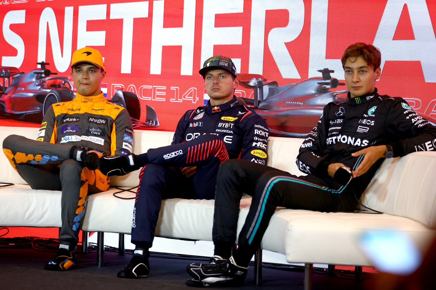 Pole position qualifier Max Verstappen of the Netherlands and Oracle Red Bull Racing (C), Second placed qualifier Lando Norris of Great Britain and McLaren (L) and Third placed qualifier George Russell of Great Britain and Mercedes (R) attend the press conference after qualifying ahead of the F1 Grand Prix of The Netherlands at Circuit Zandvoort on August 26, 2023 in Zandvoort, Netherlands. (Photo by Bryn Lennon/Getty Images) // Getty Images / Red Bull Content Pool