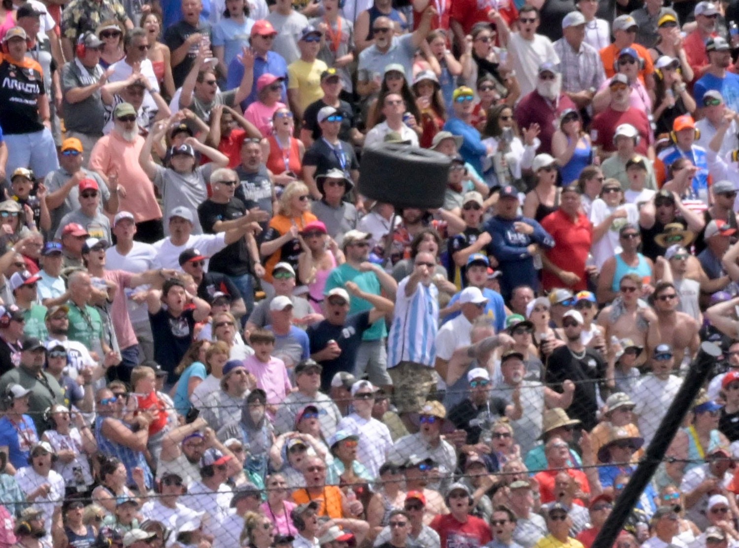 Kyle Kirkwood's wheel flies over the Catch Fence and into a Parking Lot during Indy 500