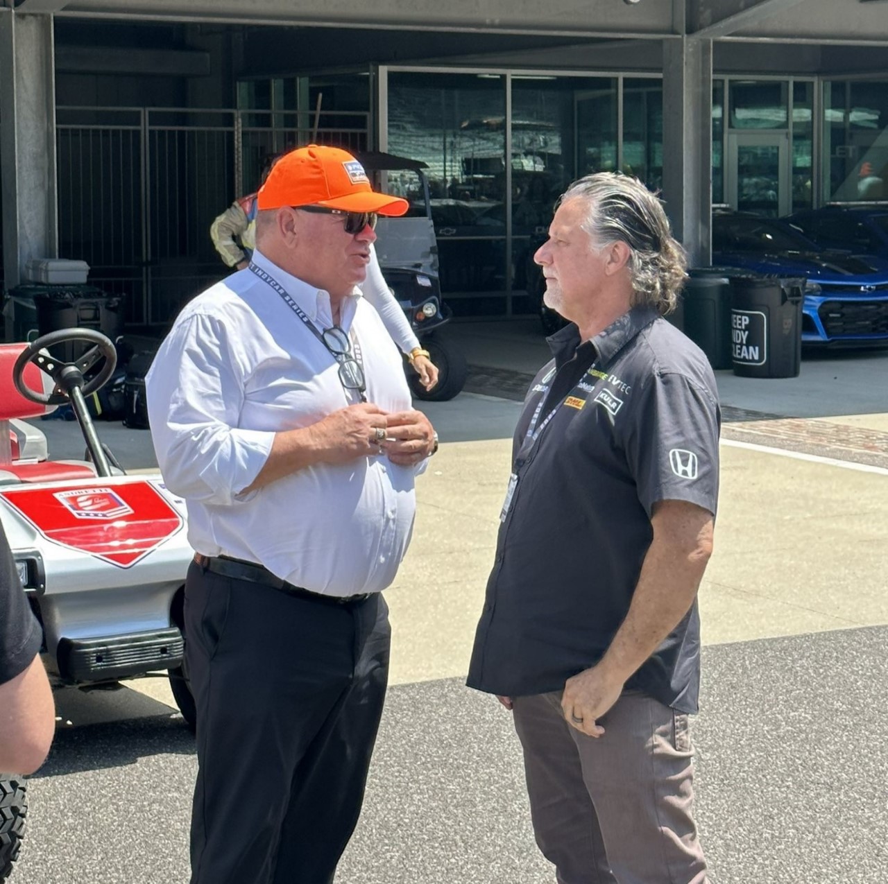 Chip Ganassi and Michael Andretti talk before the Gallagher GP on August 12, 2023 at the Indianapolis Motor Speedway.