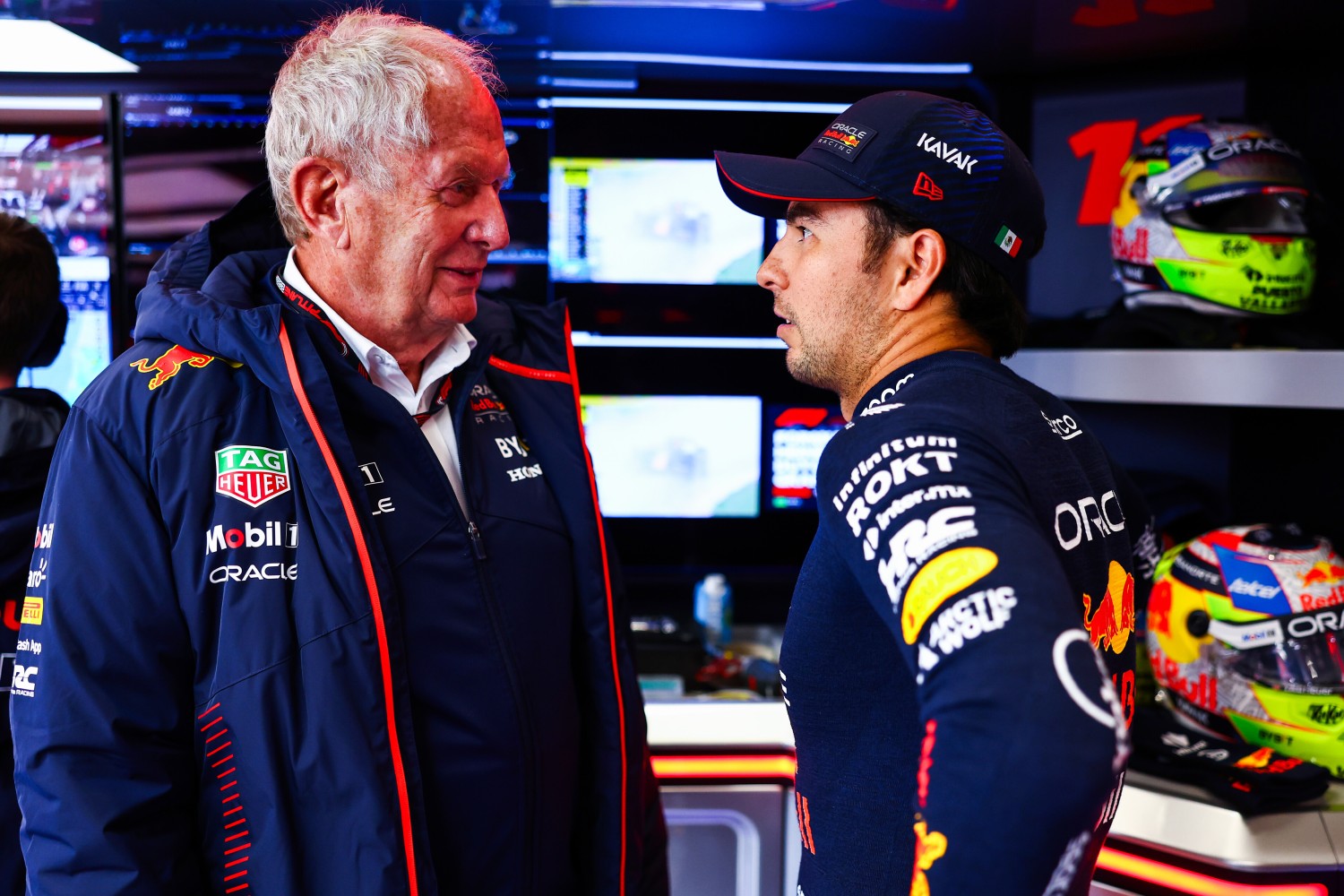 Sergio Perez of Mexico and Oracle Red Bull Racing talks with Red Bull Racing Team Consultant Dr Helmut Marko in the garage during qualifying ahead of the F1 Grand Prix of The Netherlands at Circuit Zandvoort on August 26, 2023 in Zandvoort, Netherlands. (Photo by Mark Thompson/Getty Images) // Getty Images / Red Bull Content Pool
