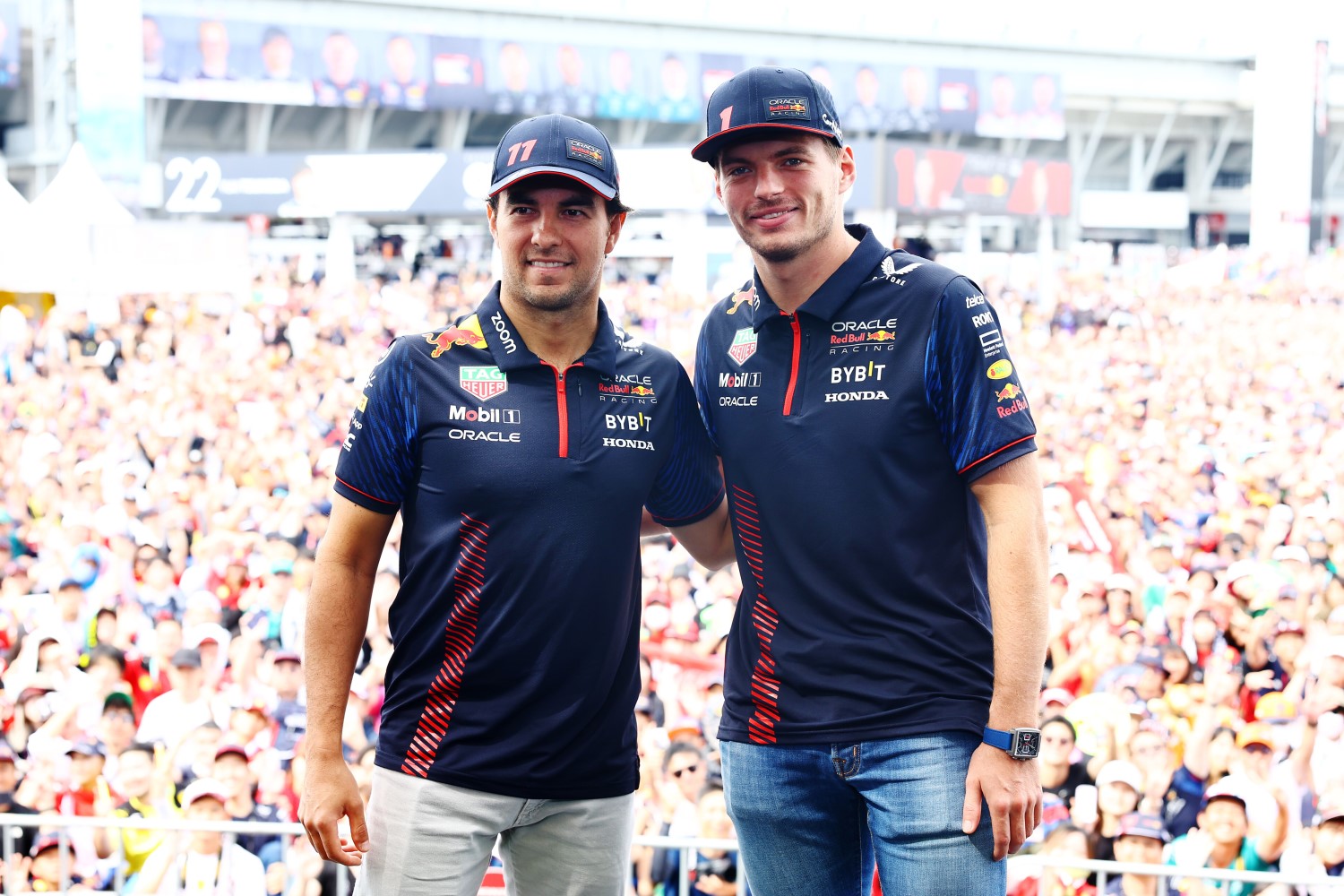 Sergio Perez of Mexico and Oracle Red Bull Racing and Max Verstappen of the Netherlands and Oracle Red Bull Racing pose for a photo on the fan stage prior to final practice ahead of the F1 Grand Prix of Japan at Suzuka International Racing Course on September 23, 2023 in Suzuka, Japan. (Photo by Mark Thompson/Getty Images) // Getty Images / Red Bull Content Pool