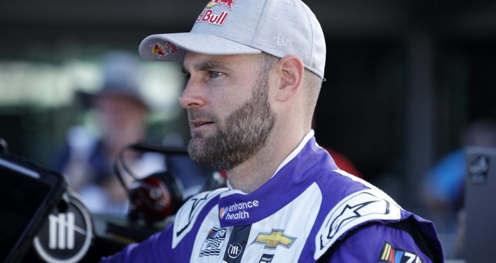 Shane Van Gisbergen, driver of the #91 Enhance Health Chevrolet, looks on in the garage area during practice for the NASCAR Cup Series Verizon 200 at the Brickyard at Indianapolis Motor Speedway on August 12, 2023 in Indianapolis, Indiana. (Photo by Justin Casterline/Getty Images) | Getty Images for NASCAR