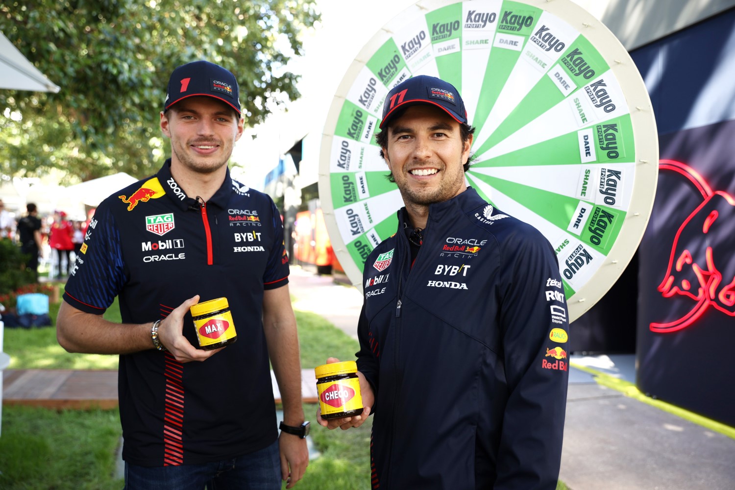 Max Verstappen of the Netherlands and Oracle Red Bull Racing and Sergio Perez of Mexico and Oracle Red Bull Racing take part in a Kayo Sports challenge in the Paddock during previews ahead of the F1 Grand Prix of Australia at Albert Park Grand Prix Circuit on March 30, 2023 in Melbourne, Australia. (Photo by Robert Cianflone/Getty Images) // Getty Images / Red Bull Content Pool 