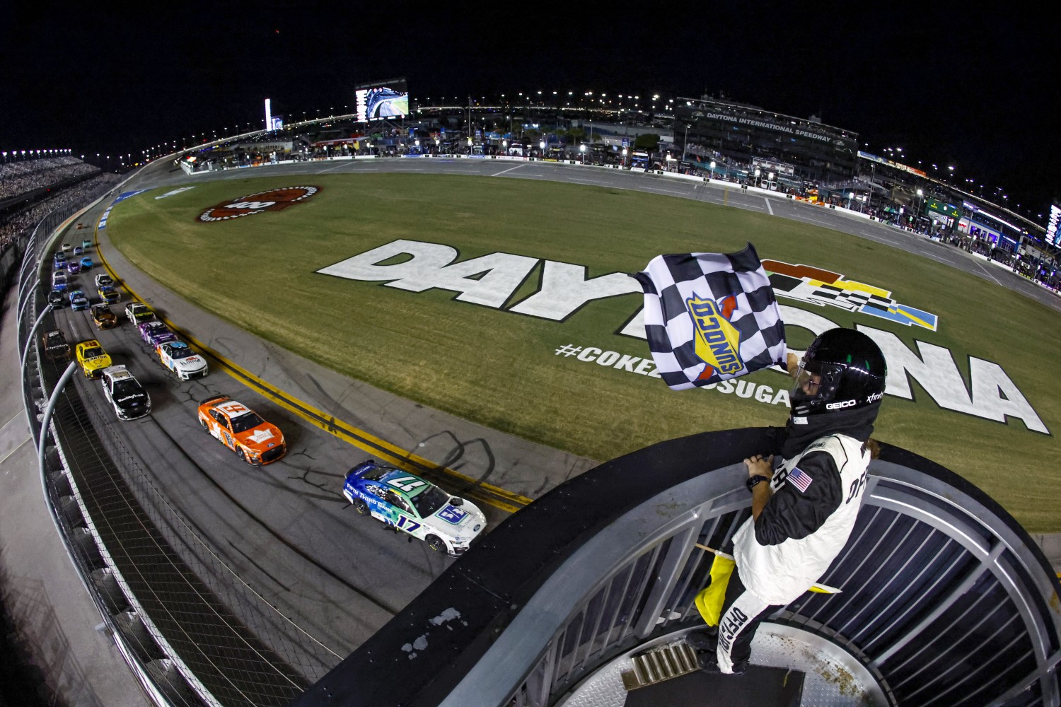 Chris Buescher, driver of the #17 Fifth Third Bank Ford, takes the checkered flag to win the NASCAR Cup Series Coke Zero Sugar 400 at Daytona International Speedway on August 26, 2023 in Daytona Beach, Florida. (Photo by James Gilbert/Getty Images)