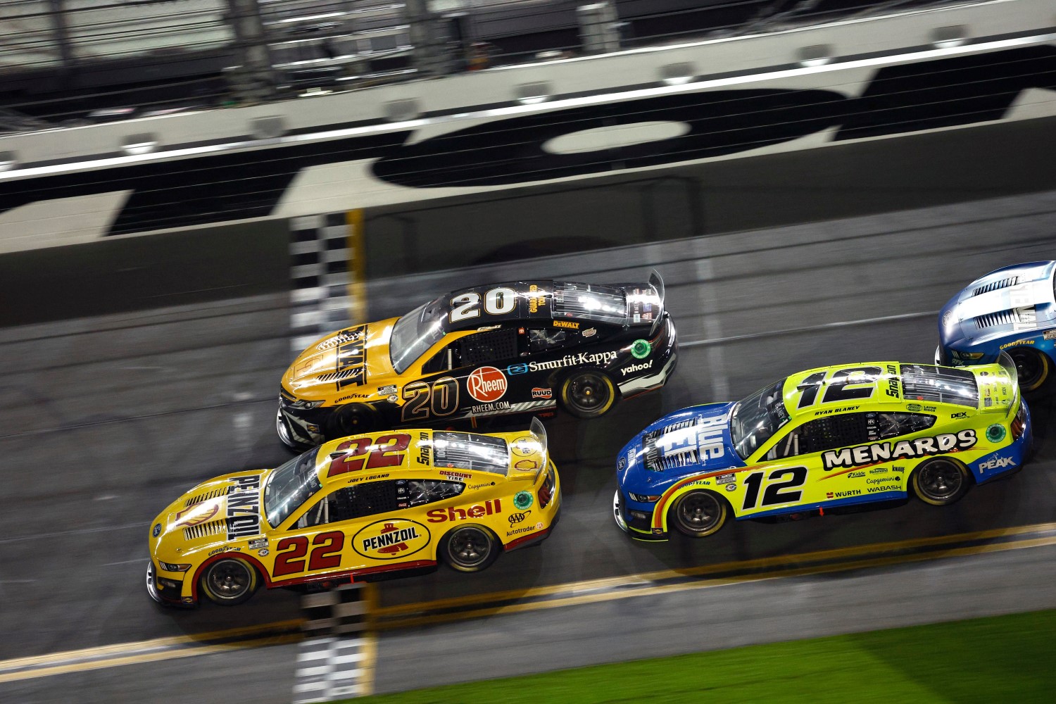 oey Logano, driver of the #22 Shell Pennzoil Ford, crosses the finish line ahead o Christopher Bell, driver of the #20 DeWalt/Rheem Toyota, and Ryan Blaney, driver of the #12 Menards/Blue DEF/PEAK Ford, to win the NASCAR Cup Series Bluegreen Vacations Duel #1 at Daytona International Speedway on February 16, 2023 in Daytona Beach, Florida. (Photo by Jared C. Tilton/Getty Images)