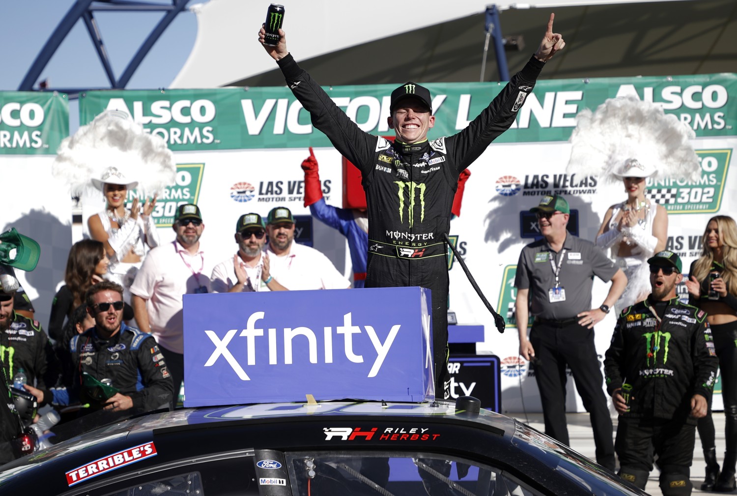 Riley Herbst, driver of the #98 Monster Energy Ford, celebrates in victory lane after winning the NASCAR Xfinity Series Alsco Uniforms 302 at Las Vegas Motor Speedway on October 14, 2023 in Las Vegas, Nevada. (Photo by Chris Graythen/Getty Images)