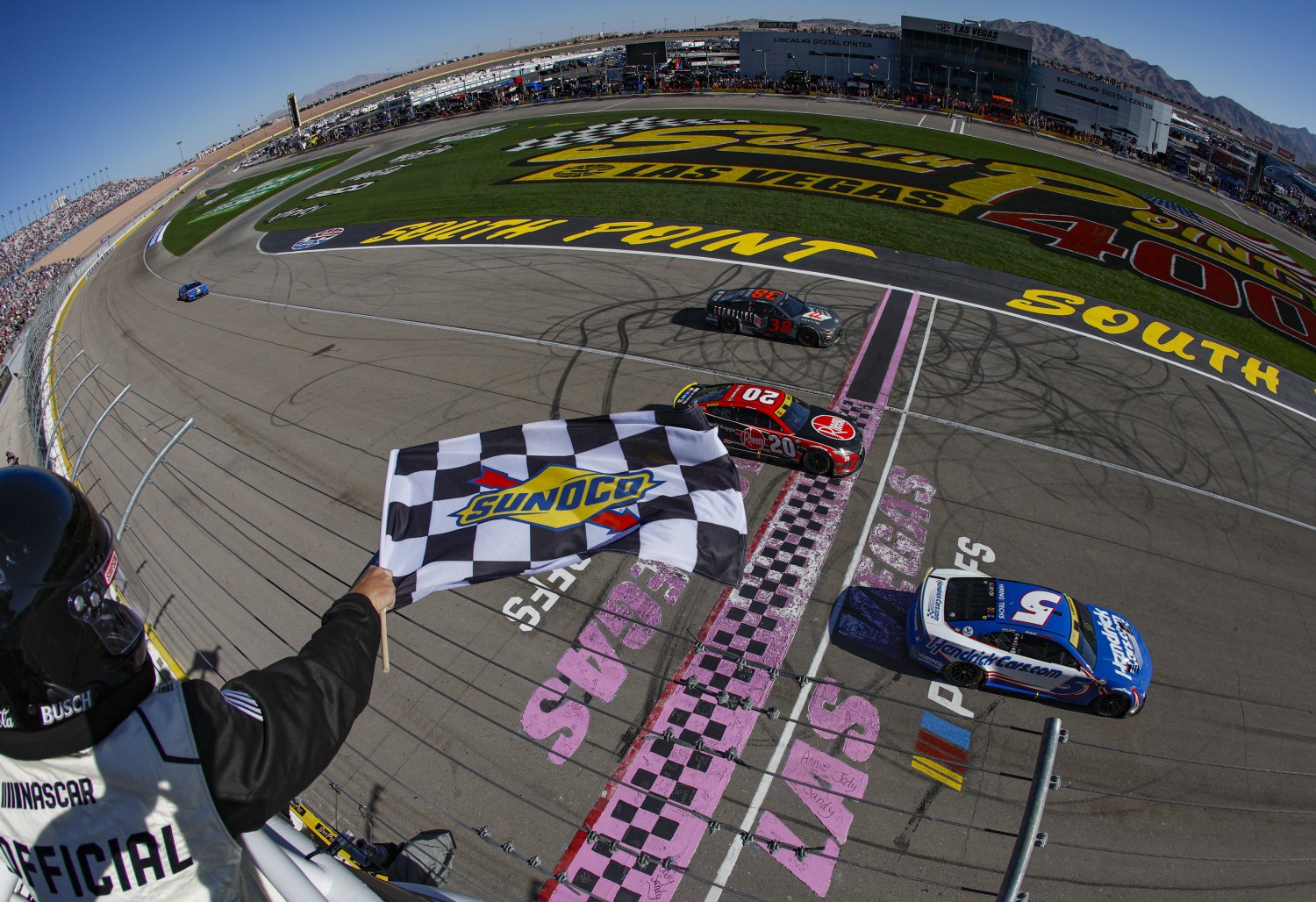 Kyle Larson, driver of the #5 HendrickCars.com Chevrolet, takes the checkered flag over Christopher Bell, driver of the #20 Rheem/Smurfit Kappa Toyota, to win the NASCAR Cup Series South Point 400 at Las Vegas Motor Speedway on October 15, 2023 in Las Vegas, Nevada. (Photo by Sean Gardner/Getty Images)