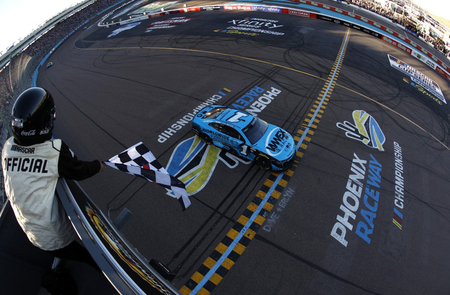 Ross Chastain, driver of the #1 Worldwide Express Chevrolet, takes the checkered flag to win the NASCAR Cup Series Championship race at Phoenix Raceway on November 05, 2023 in Avondale, Arizona. (Photo by Sean Gardner/Getty Images)