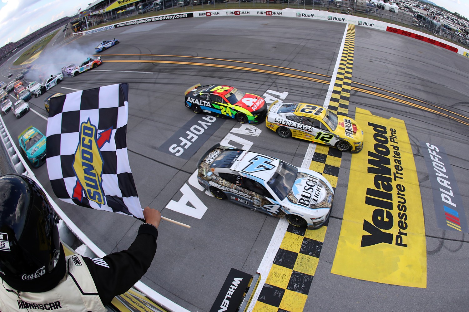 Ryan Blaney, driver of the #12 Menards/Pennzoil Ford, takes the crosses the finish line ahead of Kevin Harvick, driver of the #4 Busch Light Camo Ford, to win the NASCAR Cup Series YellaWood 500 at Talladega Superspeedway on October 01, 2023 in Talladega, Alabama. (Photo by Meg Oliphant/Getty Images)