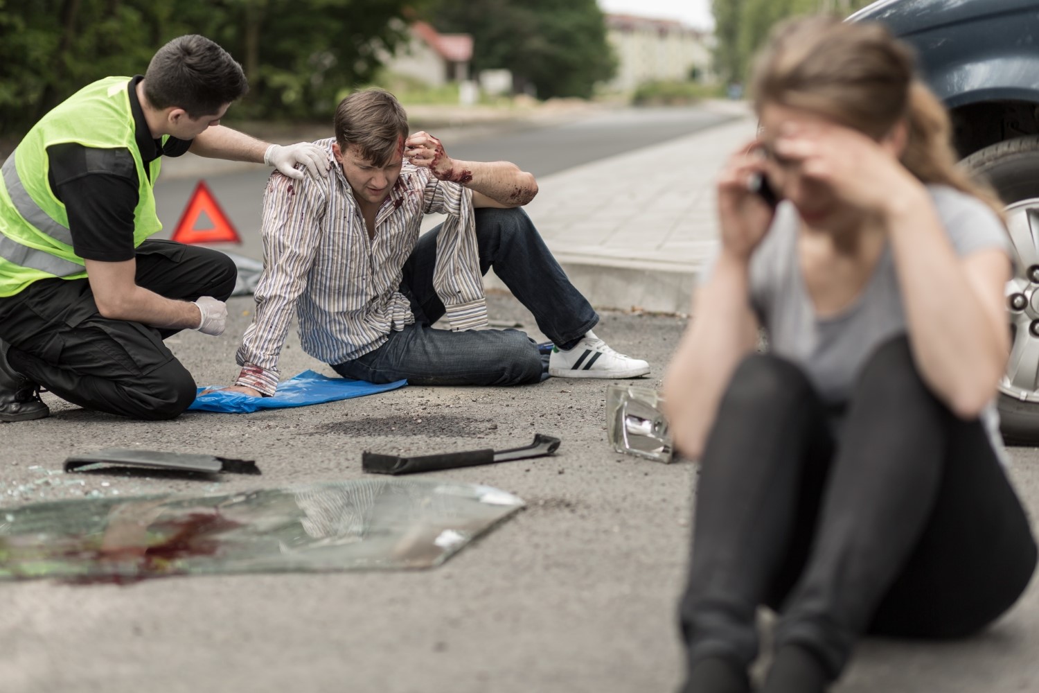 People sitting on the road after car crash