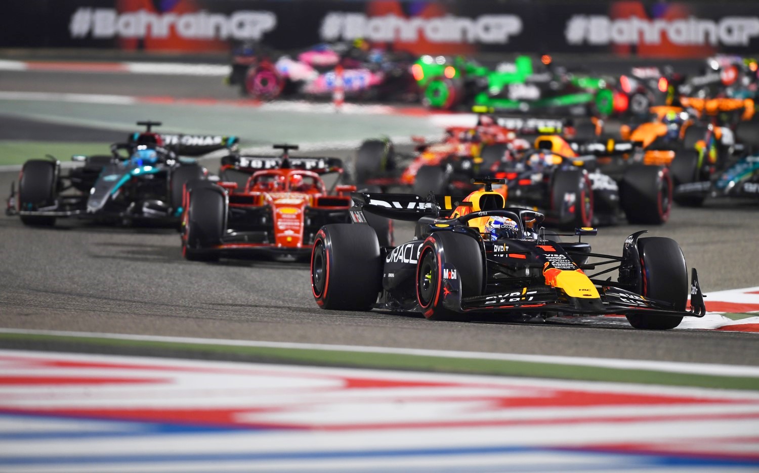 Max Verstappen of the Netherlands driving the (1) Oracle Red Bull Racing RB20 leads Charles Leclerc of Monaco driving the (16) Ferrari SF-24 and the rest of the field during the F1 Grand Prix of Bahrain at Bahrain International Circuit on March 02, 2024 in Bahrain, Bahrain. (Photo by Rudy Carezzevoli/Getty Images) // Getty Images / Red Bull Content Pool