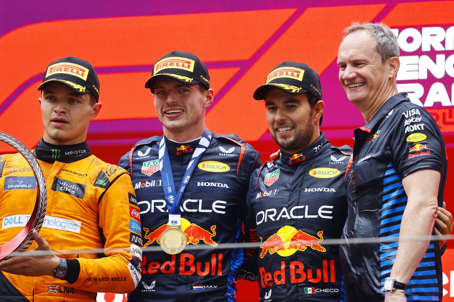 Lando Norris, McLaren F1 Team, 2nd position, Max Verstappen, Red Bull Racing, 1st position, Sergio Perez, Red Bull Racing, 3rd position, and Paul Monaghan, Chief Engineer, Red Bull Racing, on the podium during the Chinese GP at Shanghai International Circuit on Sunday April 21, 2024 in Shanghai, China. (Photo by Andy Hone / LAT Images for Pirelli)