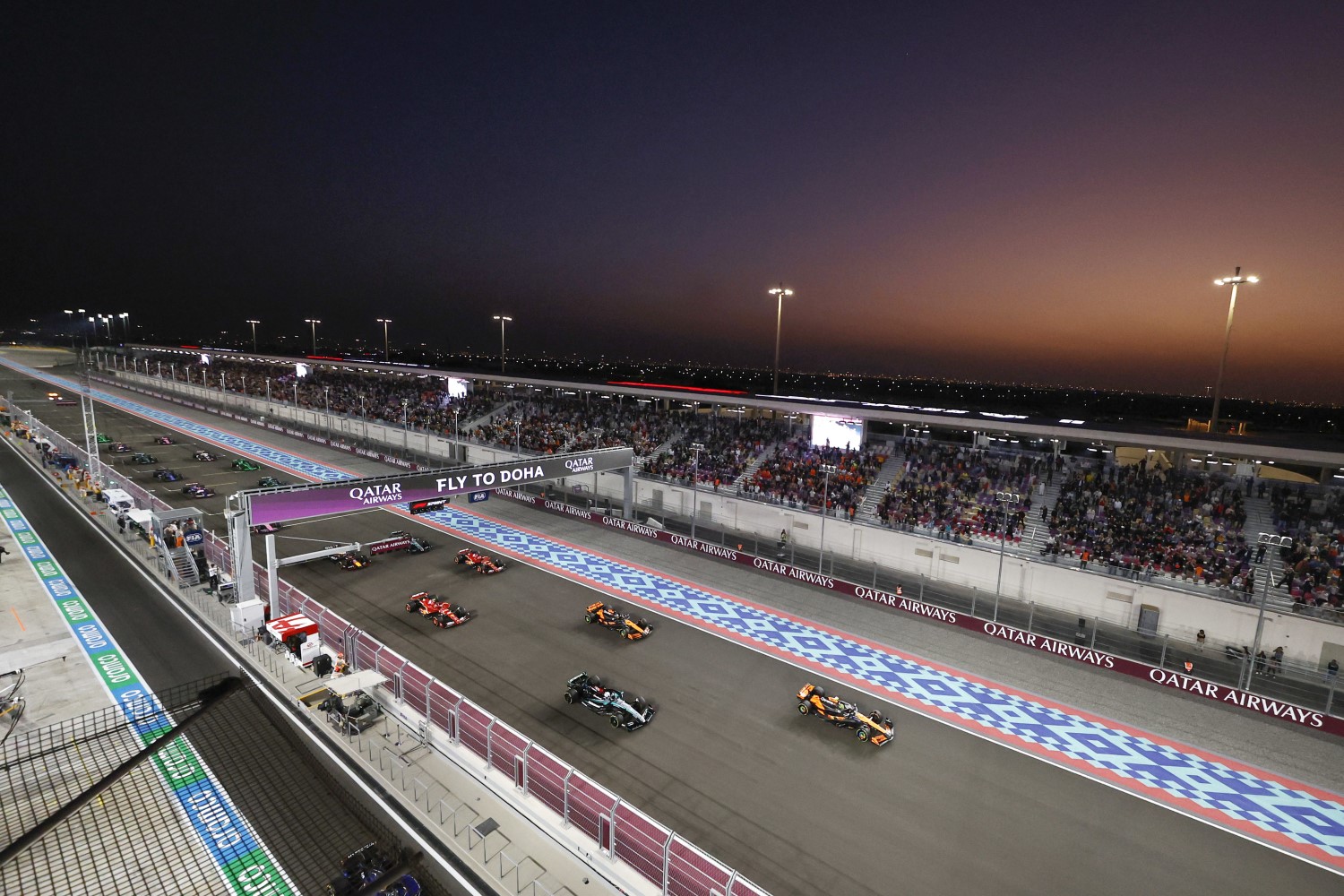 Lando Norris, McLaren MCL38, leads George Russell, Mercedes F1 W15, Oscar Piastri, McLaren MCL38 during the Qatar GP at Losail International Circuit on Saturday November 30, 2024 in Losail, Qatar. (Photo by Steven Tee / LAT Images)