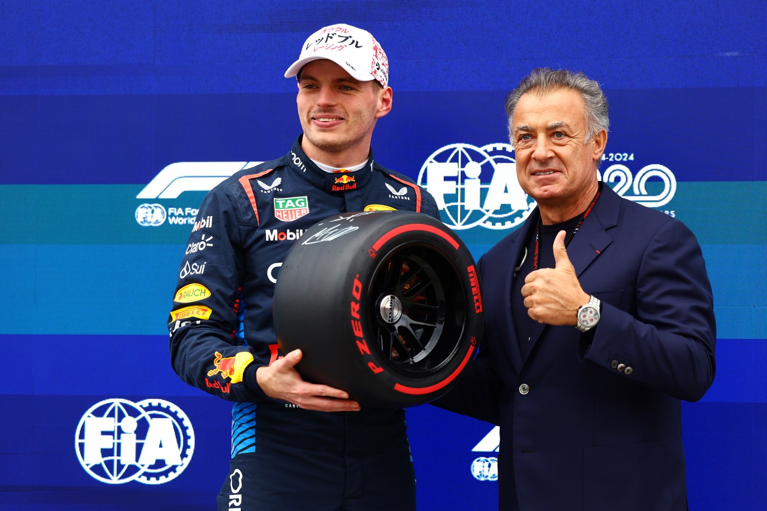 Pole position qualifier Max Verstappen of the Netherlands and Oracle Red Bull Racing is presented with the Pirelli Pole Position trophy by Jean Alesi in parc ferme during qualifying ahead of the F1 Grand Prix of Japan at Suzuka International Racing Course on April 06, 2024 in Suzuka, Japan. (Photo by Mark Thompson/Getty Images)
