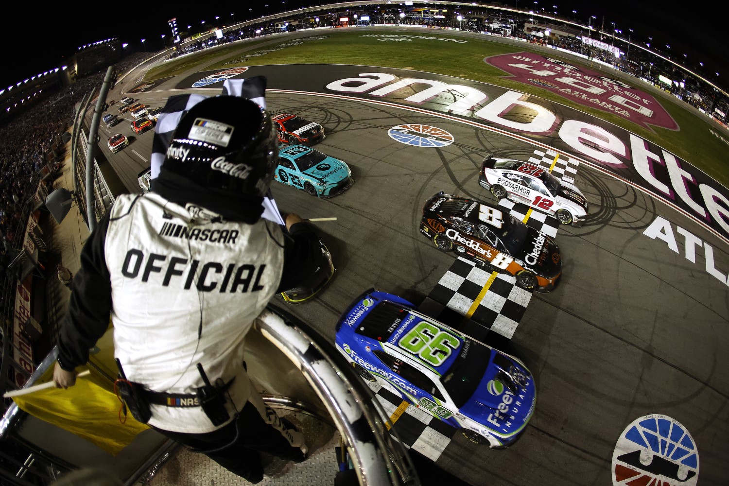 Daniel Suarez, driver of the #99 Freeway Insurance Chevrolet, crosses the finish line ahead of Kyle Busch, driver of the #8 Cheddar's Scratch Kitchen Chevrolet, and Ryan Blaney, driver of the #12 BodyArmor Zero Sugar Ford, to win the NASCAR Cup Series Ambetter Health 400 at Atlanta Motor Speedway on February 25, 2024 in Hampton, Georgia. (Photo by Alex Slitz/Getty Images)