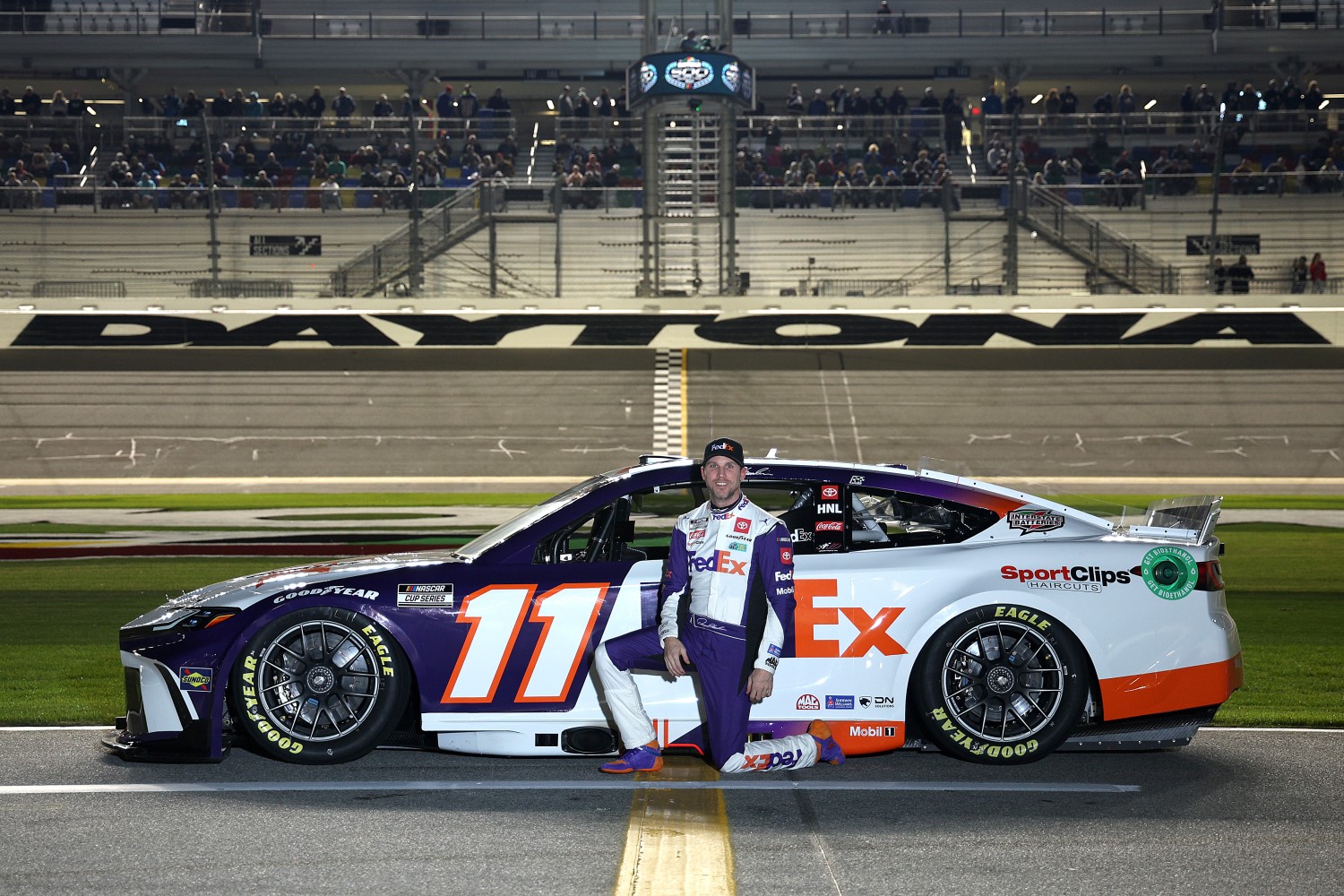 Denny Hamlin, driver of the #11 FedEx Toyota, poses for a photo on the grid during qualifying for the NASCAR Cup Series Daytona 500 at Daytona International Speedway on February 14, 2024 in Daytona Beach, Florida. (Photo by Jared C. Tilton/Getty Images)