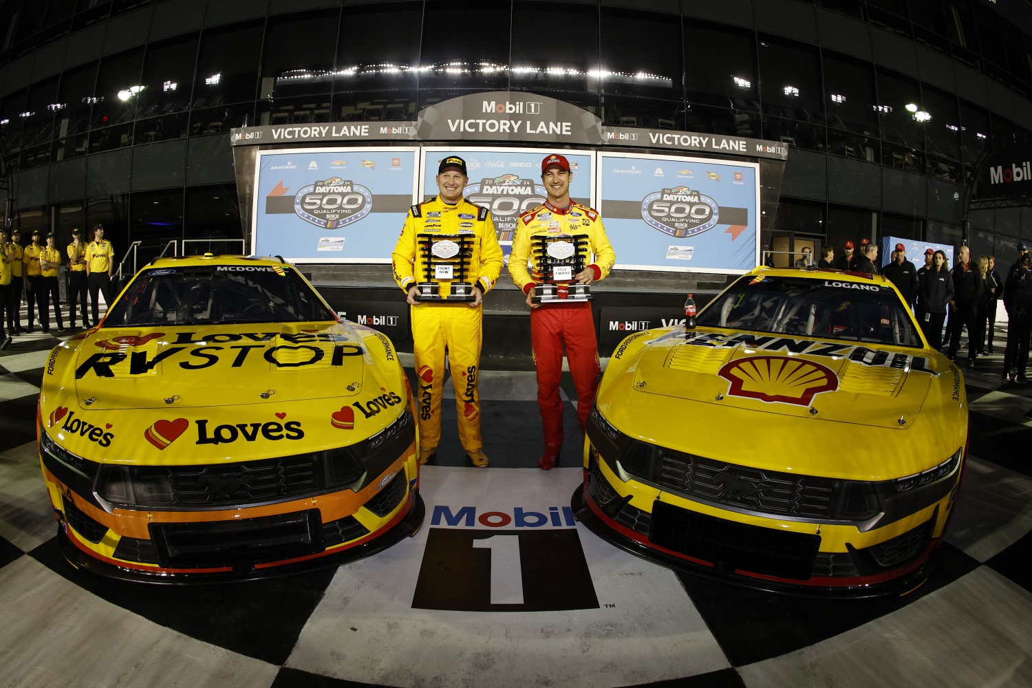 Joey Logano, driver of the #22 Shell Pennzoil Ford, (R) winner of the Daytona 500 pole award and Michael McDowell, driver of the #34 Love's Travel Stops Ford, Front Row second fastest winner pose for a photo during qualifying for the NASCAR Cup Series Daytona 500 at Daytona International Speedway on February 14, 2024 in Daytona Beach, Florida. (Photo by Sean Gardner/Getty Images)