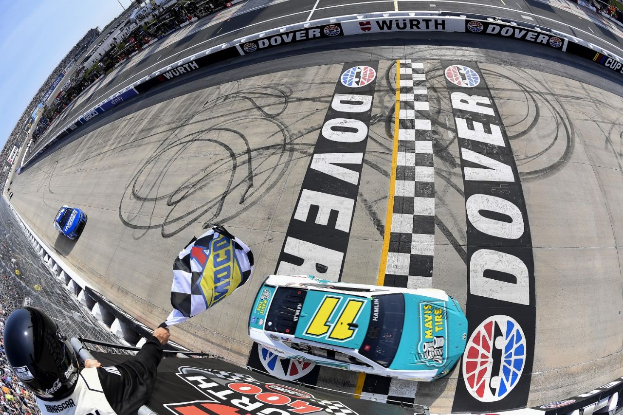 Denny Hamlin, driver of the #11 Mavis Tire Toyota, takes the checkered flag to win the NASCAR Cup Series Würth 400 at Dover International Speedway on April 28, 2024 in Dover, Delaware. (Photo by Logan Riely/Getty Images)