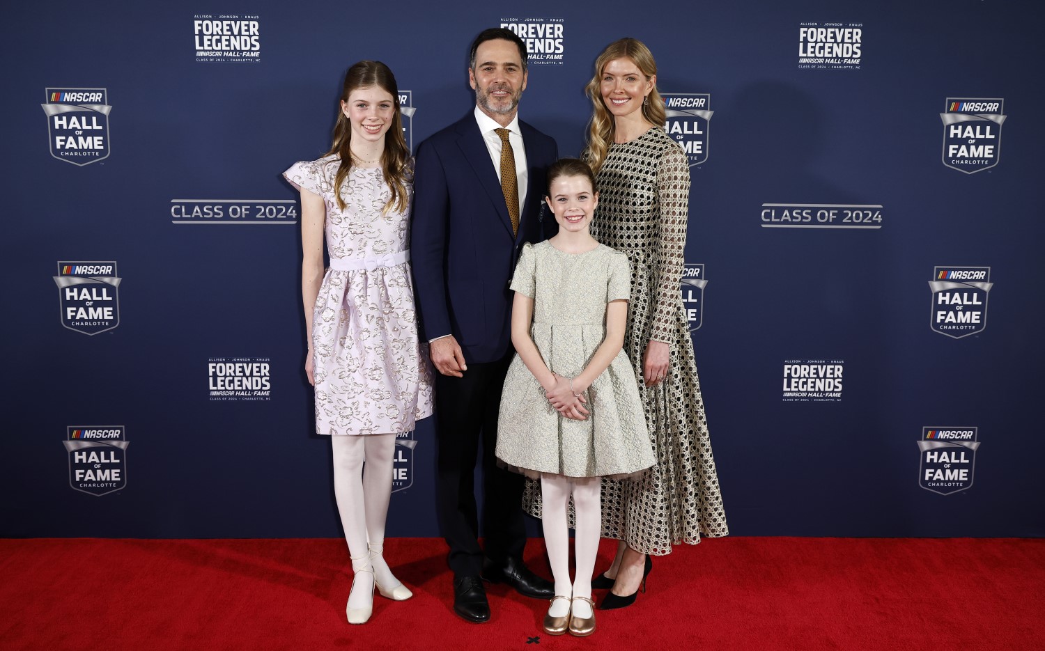 NASCAR Hall of Fame inductee Jimmie Johnson, daughters Genevieve Johnson, Lydia Norriss Johnson and wife, Chandra Johnson pose for photos on the red carpet prior to the 2024 NASCAR Hall of Fame Induction Ceremony at Charlotte Convention Center on January 19, 2024 in Charlotte, North Carolina. (Photo by Chris Graythen/Getty Images)