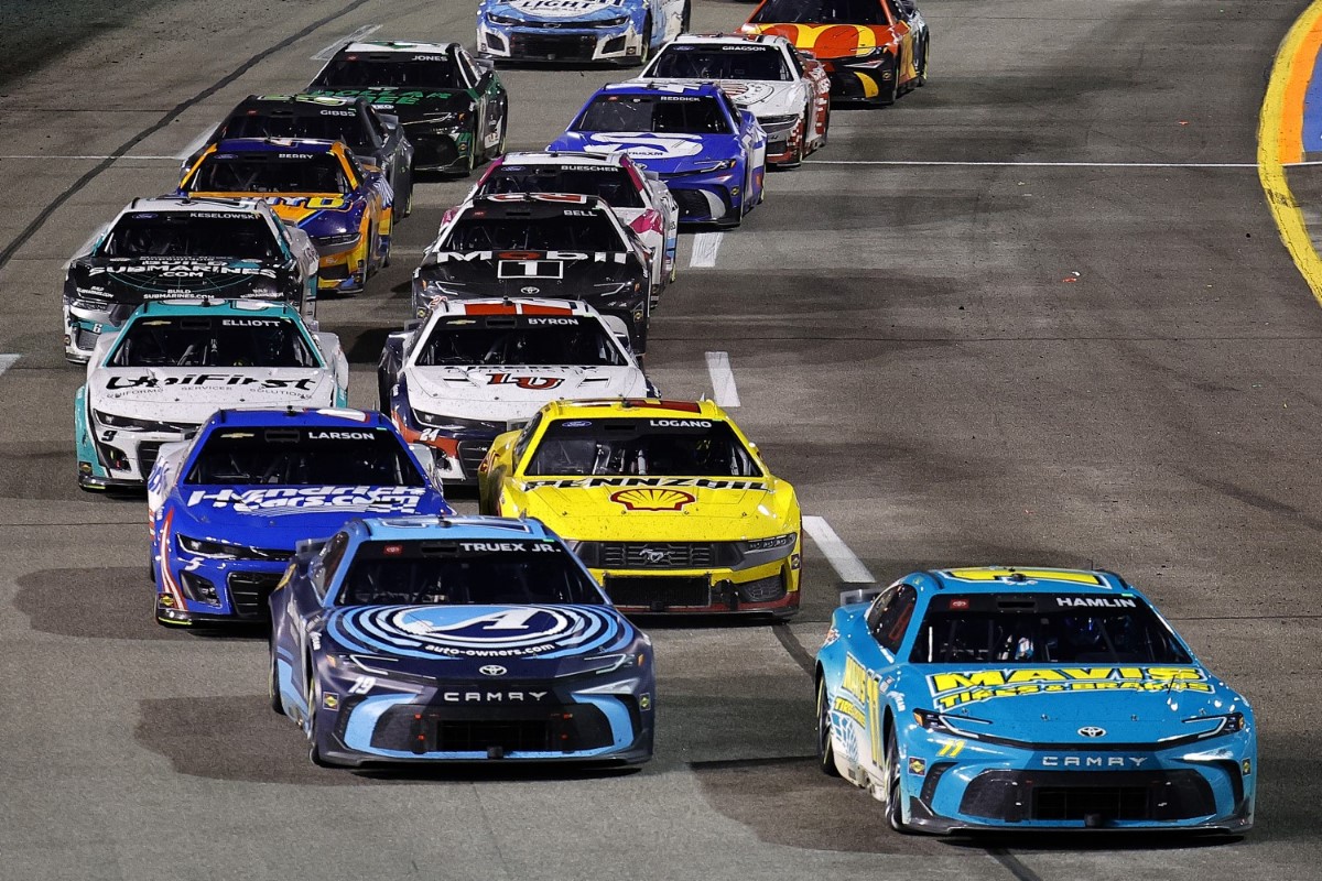 Denny Hamlin, driver of the #11 Mavis Tires &; Brakes Toyota, leads Martin Truex Jr., driver of the #19 Auto-Owners Insurance Toyota, on the restart to win the NASCAR Cup Series Toyota Owners 400 at Richmond Raceway on March 31, 2024 in Richmond, Virginia. (Photo by Alex Slitz/Getty Images)