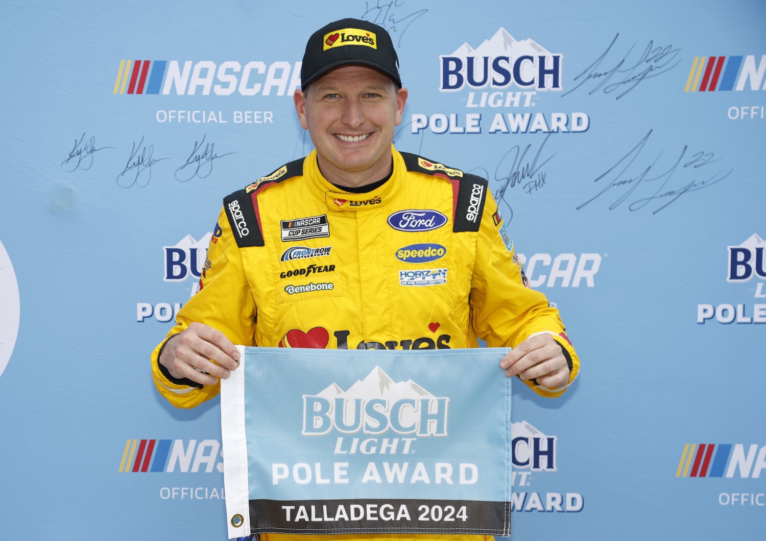 Michael McDowell, driver of the #34 Love's Travel Stops Ford, poses for photos after winning the pole award during qualifying for the NASCAR Cup Series GEICO 500 at Talladega Superspeedway on April 20, 2024 in Talladega, Alabama. (Photo by Sean Gardner/Getty Images)