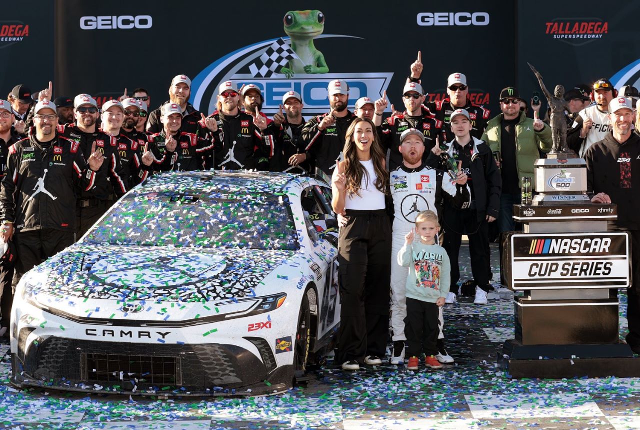 Tyler Reddick, driver of the #45 Jordan Brand Toyota, celebrates with crew and family in victory lane after winning the NASCAR Cup Series GEICO 500 at Talladega Superspeedway on April 21, 2024 in Talladega, Alabama. (Photo by James Gilbert/Getty Images)