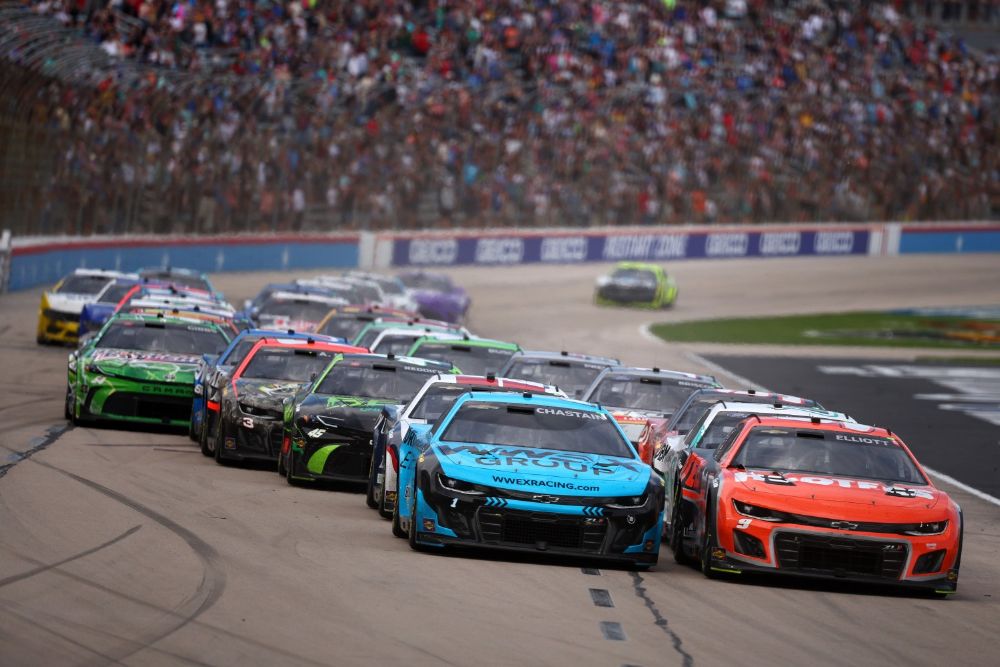 Chase Elliott, driver of the #9 Hooters Chevrolet, and Ross Chastain, driver of the #1 Worldwide Express Chevrolet, lead the field to a restart during the NASCAR Cup Series AutoTrader EchoPark Automotive 400 at Texas Motor Speedway on April 14, 2024 in Fort Worth, Texas. (Photo by Jared C. Tilton/Getty Images for NASCAR)