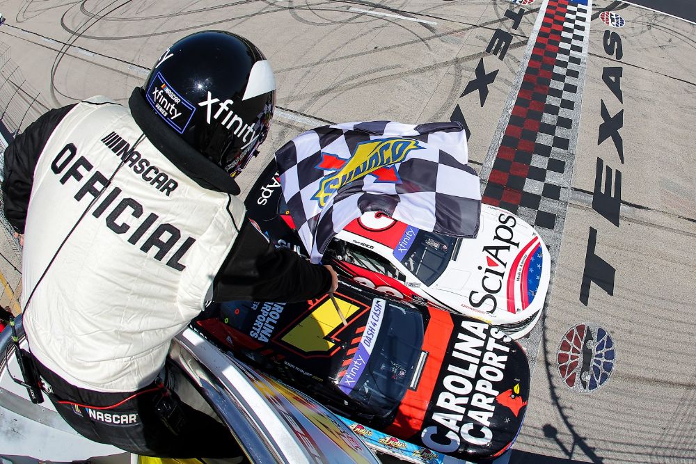 Sam Mayer, driver of the #1 Carolina Carports Chevrolet, crosses the finish line ahead of Ryan Sieg, driver of the #39 Sci Aps Ford, to win the NASCAR Xfinity Series Andy's Frozen Custard 300 at Texas Motor Speedway on April 13, 2024 in Fort Worth, Texas. (Photo by Jonathan Bachman/Getty Images)