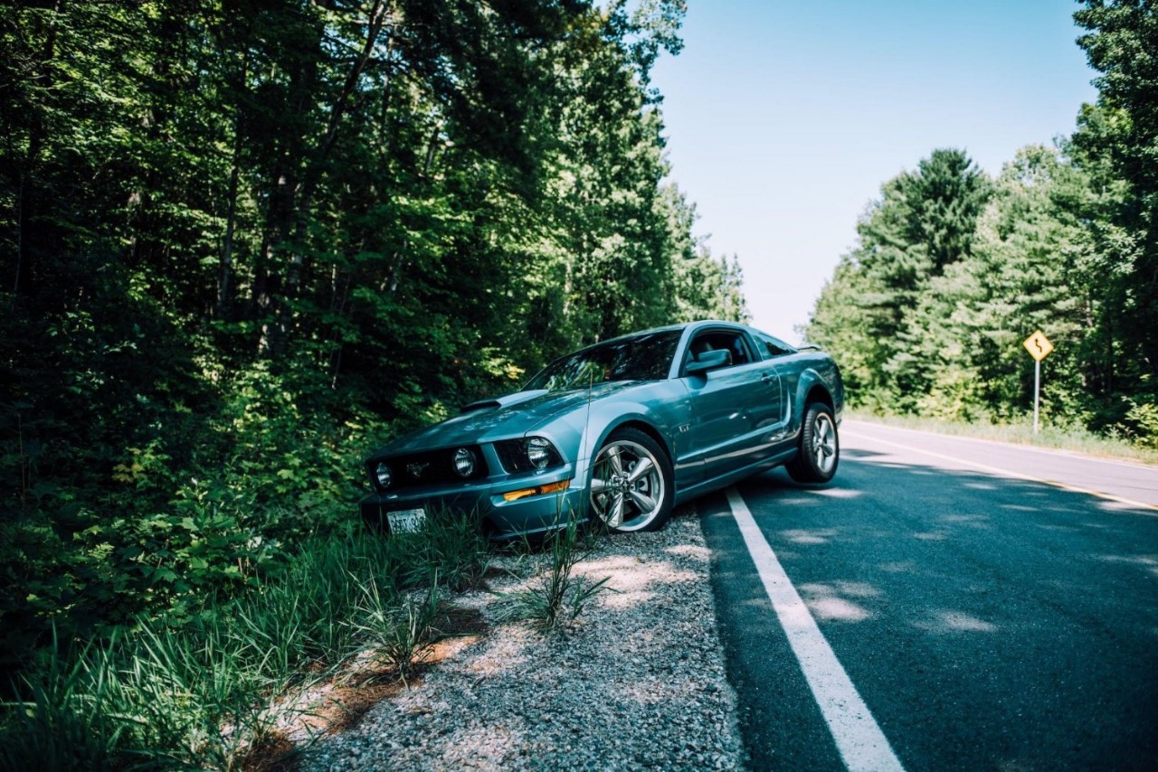 A blown tire sends Mustang driver into a ditch