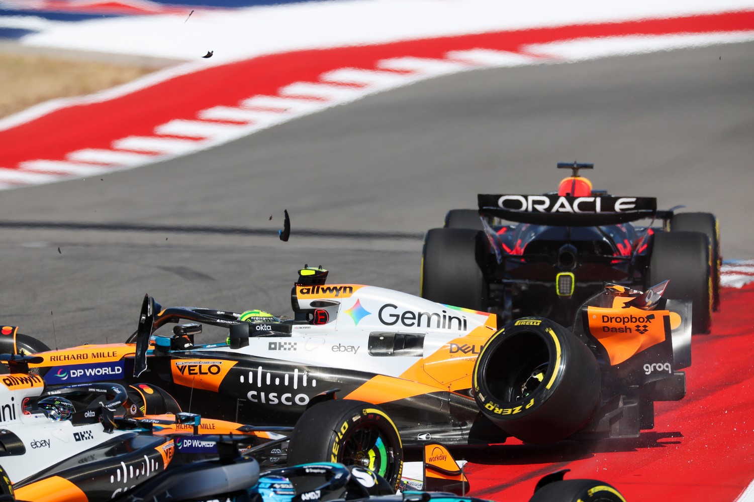 Max Verstappen of the Netherlands driving the (1) Oracle Red Bull Racing RB21 leads as Lando Norris of Great Britain driving the (4) McLaren MCL39 Mercedes and Oscar Piastri of Australia driving the (81) McLaren MCL39 Mercedes crash at the start during the Sprint ahead of the F1 Grand Prix of United States at Circuit of The Americas on October 18, 2025 in Austin, Texas. (Photo by Sam Bloxham/LAT Images) // Getty Images / Red Bull Content Pool //