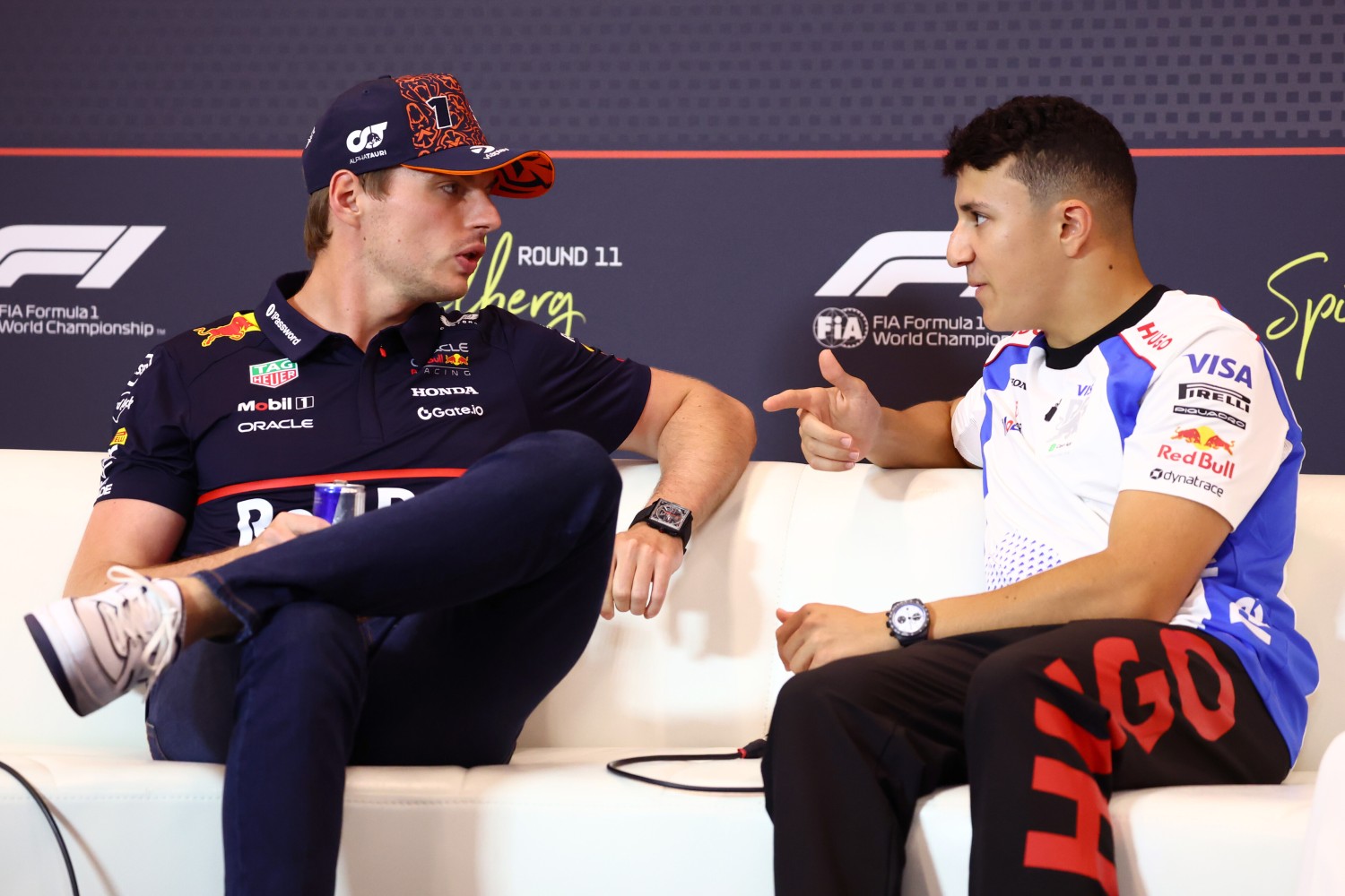 Max Verstappen of the Netherlands and Oracle Red Bull Racing and Isack Hadjar of France and Visa Cash App Racing Bulls talk in the Drivers Press Conference during previews ahead of the F1 Grand Prix of Austria at Red Bull Ring on June 26, 2025 in Spielberg, Austria. (Photo by Clive Rose/Getty Images) // Getty Images / Red Bull Content Pool //