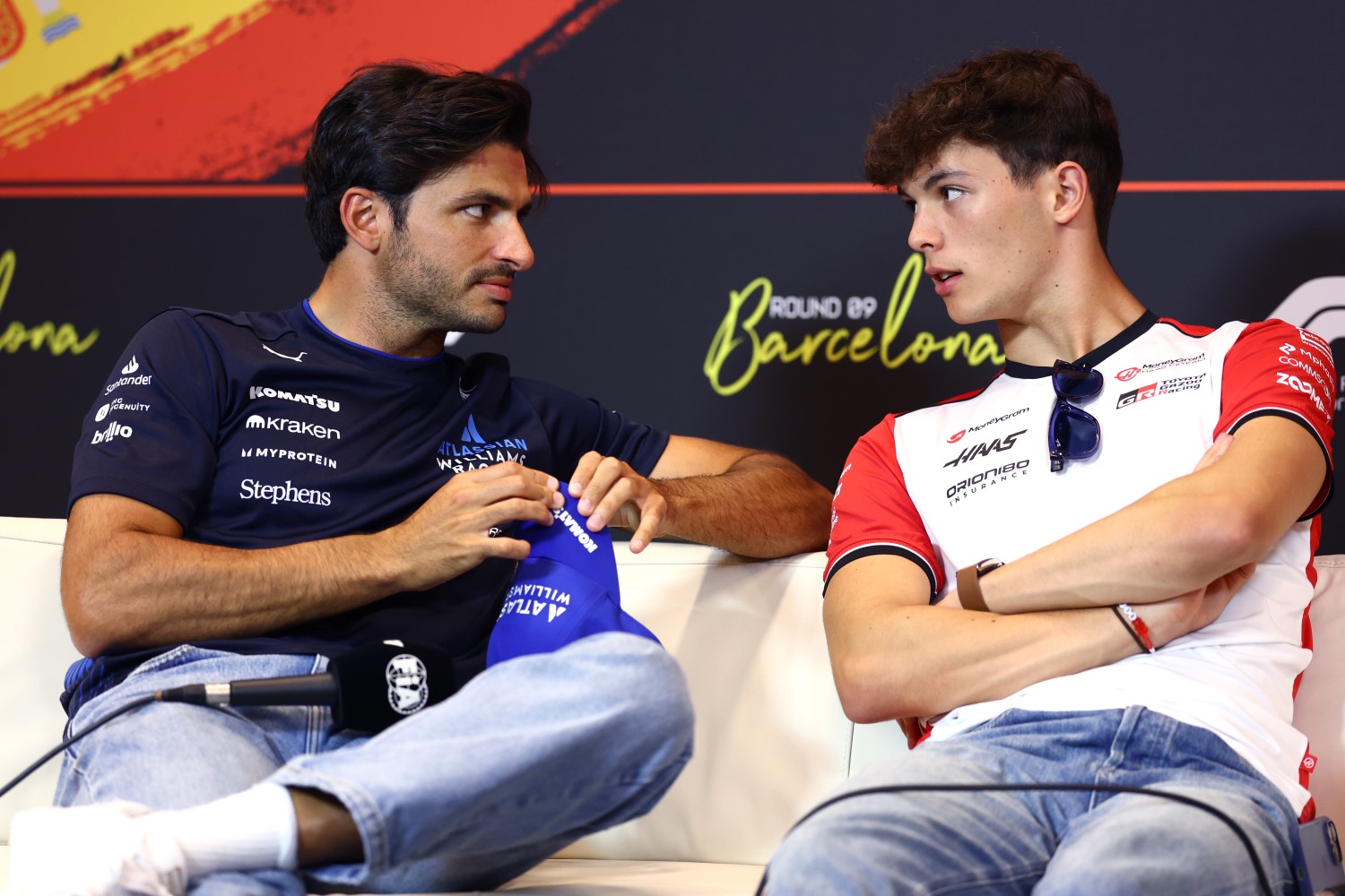 Carlos Sainz Jr. of Spain and Williams and Oliver Bearman of Great Britain and Haas F1 talk in the Drivers Press Conference during previews ahead of the F1 GP of Spain at Circuit de Barcelona-Catalunya on May 29, 2025 in Barcelona, Spain. (Photo by Clive Rose/Getty Images)