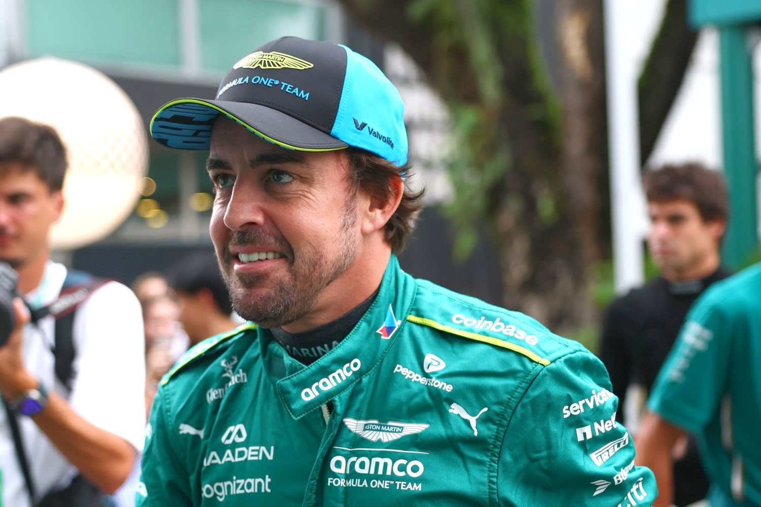 Fernando Alonso of Spain and Aston Martin F1 Team walks in the Paddock prior to practice ahead of the F1 Grand Prix of Singapore at Marina Bay Street Circuit on October 03, 2025 in Singapore, Singapore. (Photo by Zak Mauger/LAT Images for Aston Martin)