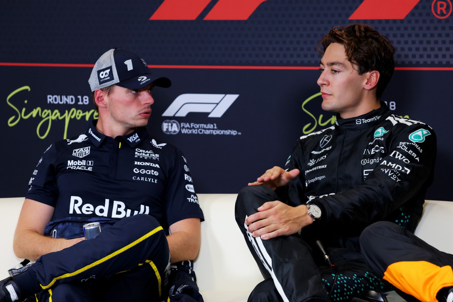 Pole position qualifier George Russell of Great Britain and Mercedes AMG Petronas F1 Team and Second placed qualifier Max Verstappen of the Netherlands and Oracle Red Bull Racing in the Drivers Press Conference during qualifying ahead of the F1 Grand Prix of Singapore at Marina Bay Street Circuit on October 04, 2025 in Singapore, Singapore. (Photo by Clive Rose/Getty Images) // Getty Images / Red Bull Content Pool // 