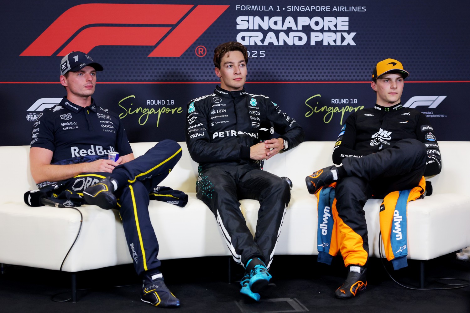 Pole position qualifier George Russell of Great Britain and Mercedes AMG Petronas F1 Team Second placed qualifier Max Verstappen of the Netherlands and Oracle Red Bull Racing and Third placed qualifier Oscar Piastri of Australia and McLaren in the Drivers Press Conference during qualifying ahead of the F1 Grand Prix of Singapore at Marina Bay Street Circuit on October 04, 2025 in Singapore, Singapore. (Photo by Clive Rose/Getty Images) // Getty Images / Red Bull Content Pool //