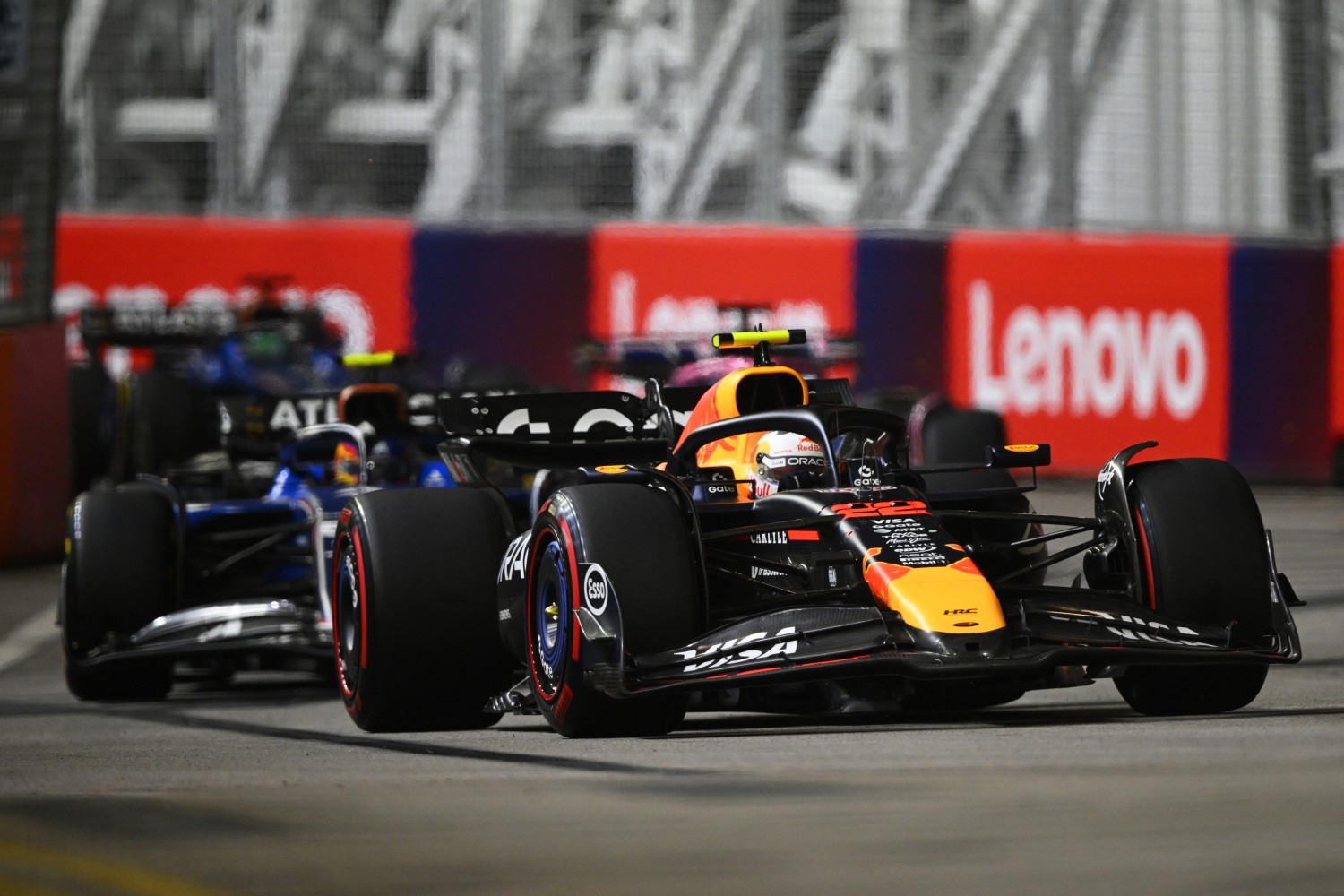 Yuki Tsunoda of Japan driving the (22) Oracle Red Bull Racing RB21 leads Carlos Sainz of Spain driving the (55) Williams FW47 Mercedes on track during to the F1 Grand Prix of Singapore at Marina Bay Street Circuit on October 05, 2025 in Singapore, Singapore. (Photo by Clive Mason/Getty Images) // Getty Images / Red Bull Content Pool //