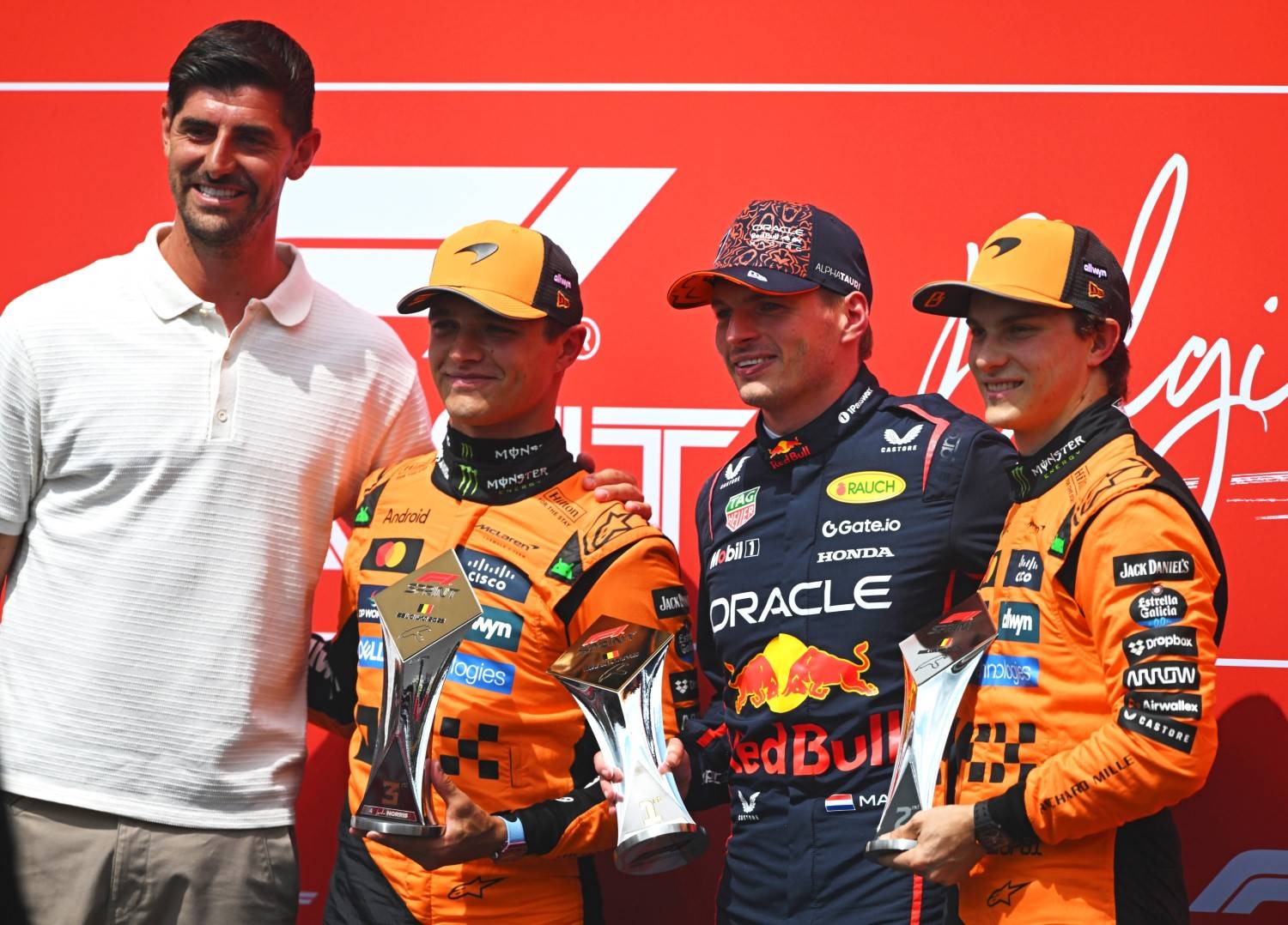 Sprint winner Max Verstappen of the Netherlands and Oracle Red Bull Racing Second placed Oscar Piastri of Australia and McLaren and Third placed Lando Norris of Great Britain and McLaren receive their trophies from Thibaut Courtois during the Sprint ahead of the F1 Grand Prix of Belgium at Circuit de Spa-Francorchamps on July 26, 2025 in Spa, Belgium. (Photo by Rudy Carezzevoli/Getty Images) // Getty Images / Red Bull Content Pool //