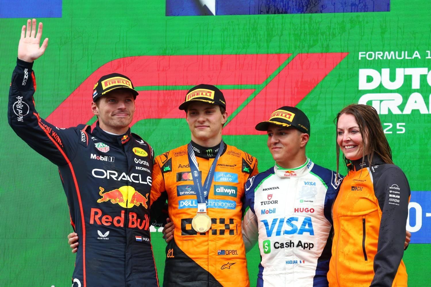 Race winner Oscar Piastri of Australia and McLaren Second placed Max Verstappen of the Netherlands and Oracle Red Bull Racing Third placed Isack Hadjar of France and Visa Cash App Racing Bulls and Laura Bowden, Chief Financial Officer at McLaren on the podium during the F1 Grand Prix of Netherlands at Circuit Zandvoort on August 31, 2025 in Zandvoort, Netherlands. (Photo by Clive Rose/Getty Images) // Getty Images / Red Bull Content Pool //